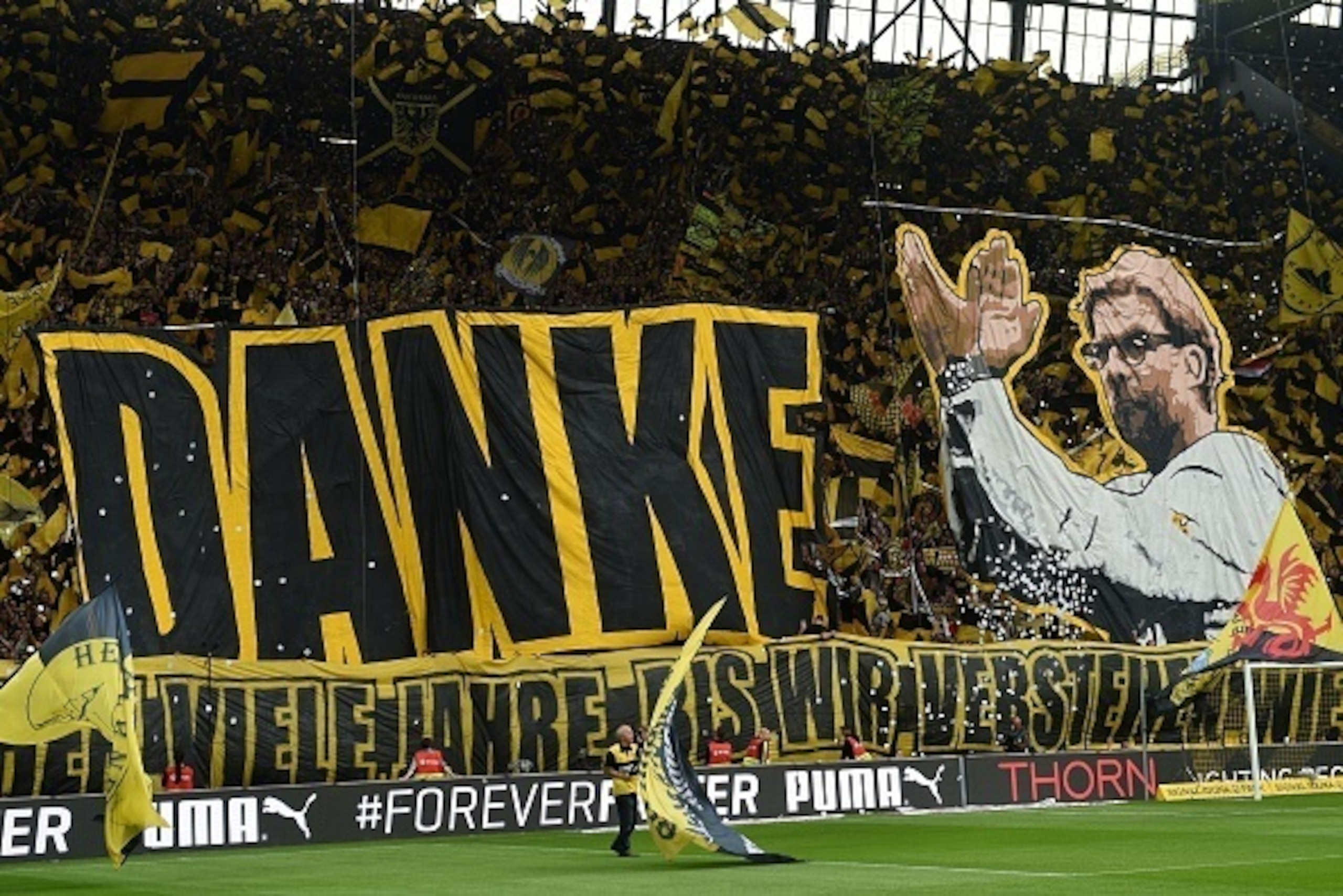 Dortmund's fans celebrate Dortmund's head coach Juergen Klopp prior to German first division Bundesliga football match between Borussia Dortmund and SV Werder Bremen at the Signal Iduna Park in Dortmund, western Germany on May 23, 2015. The match is Klopp