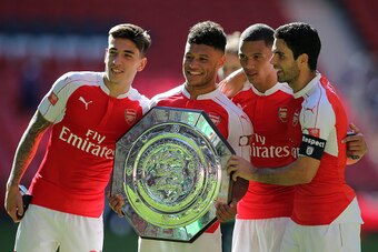 LONDON, ENGLAND -  AUGUST 2:  Arsenal goalscorer Alex Oxlade-Chamberlain celebrates with the FA Community Shield trophy with team-mates Hector Bellerin, Kieran Gibbs and Mikel Arteta after the FA Community Shield match between Chelsea and Arsenal at Wembl