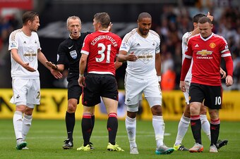 SWANSEA, WALES - AUGUST 30:  Manchester United player Bastian Schweinsteiger is spoken to by referee Martin Atkinson during the Barclays Premier League match between Swansea City and Manchester United on August 30, 2015 in Swansea, United Kingdom.  (Photo