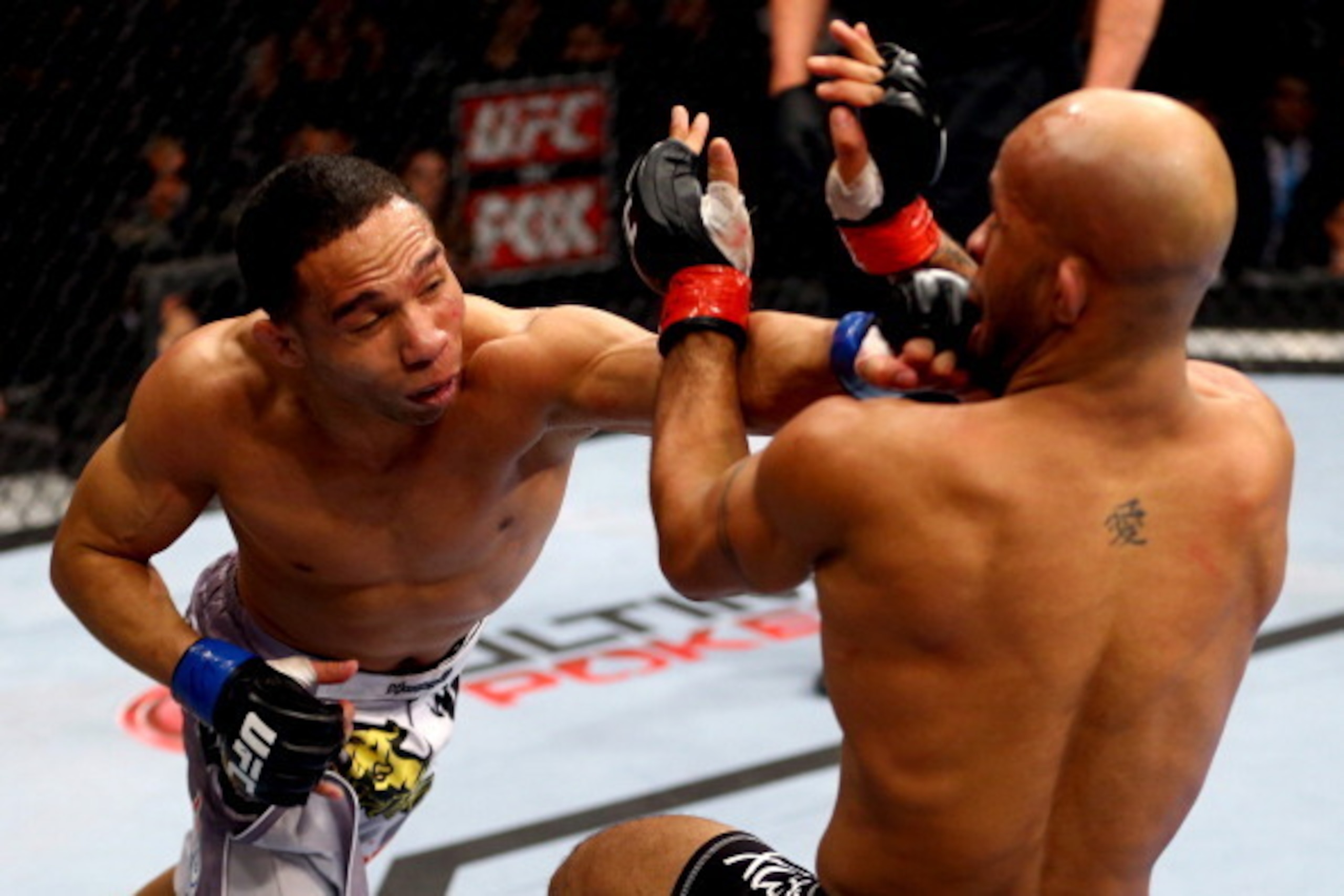 CHICAGO, IL - JANUARY 26:  John Dodson (L) punches Demetrious Johnson (R) during thier Flyweight Championship Bout part of UFC on FOX at United Center on January 26, 2013 in Chicago, Illinois.  (Photo by Al Bello/Zuffa LLC/Zuffa LLC Via Getty Images)