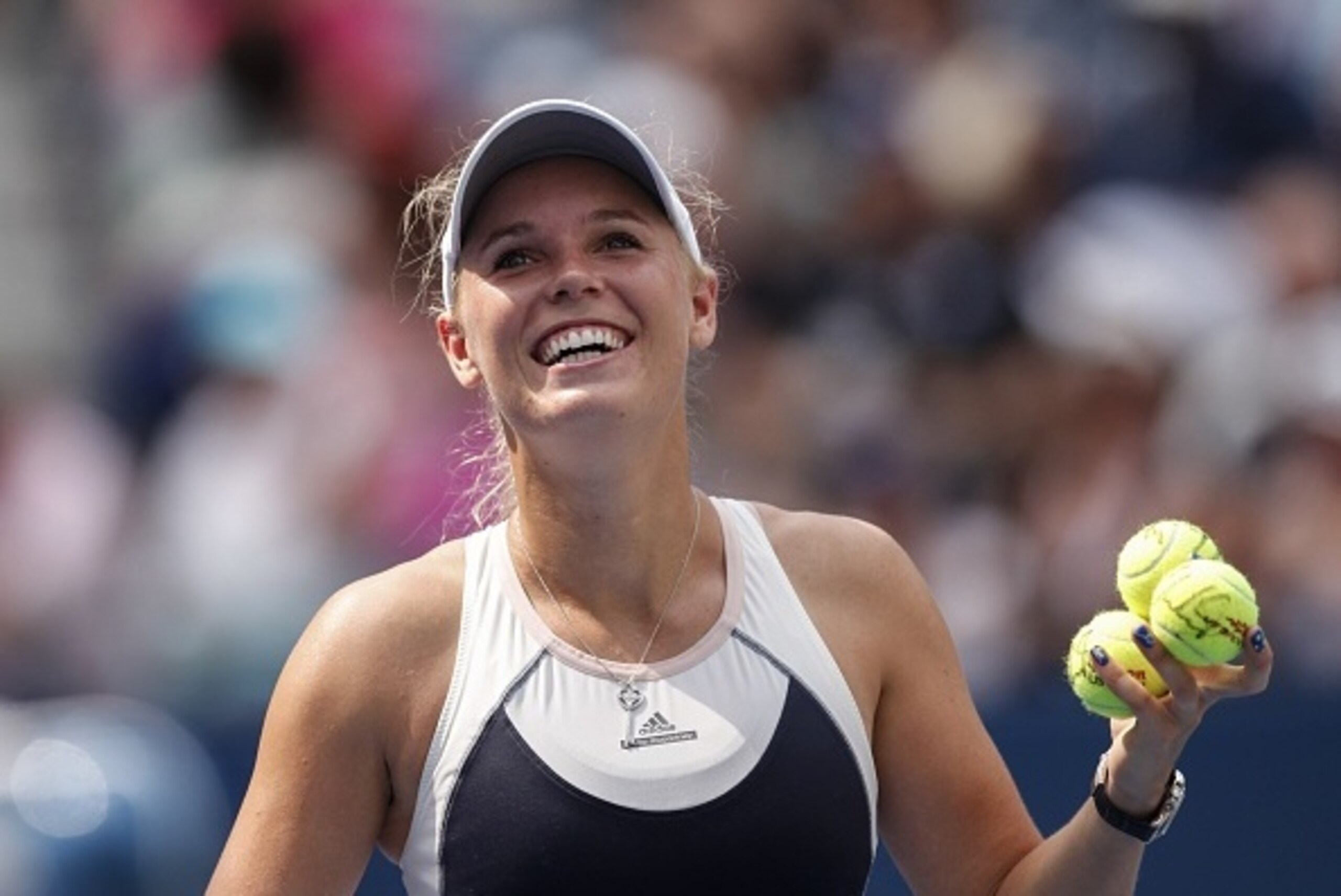 Caroline Wozniacki of Denmark hits balls to spectators after after defeating Jamie Loeb of United States during their 2015 US Open Women's Singles round 1 match at the USTA Billie Jean King National Tennis Center September 1, 2015 in New York. AFP PHOTO/K