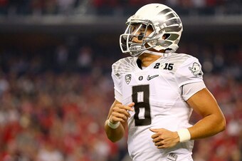 ARLINGTON, TX - JANUARY 12:  Quarterback Marcus Mariota #8 of the Oregon Ducks looks on in the first half against the Ohio State Buckeyes during the College Football Playoff National Championship Game at AT&T Stadium on January 12, 2015 in Arlington, Texa