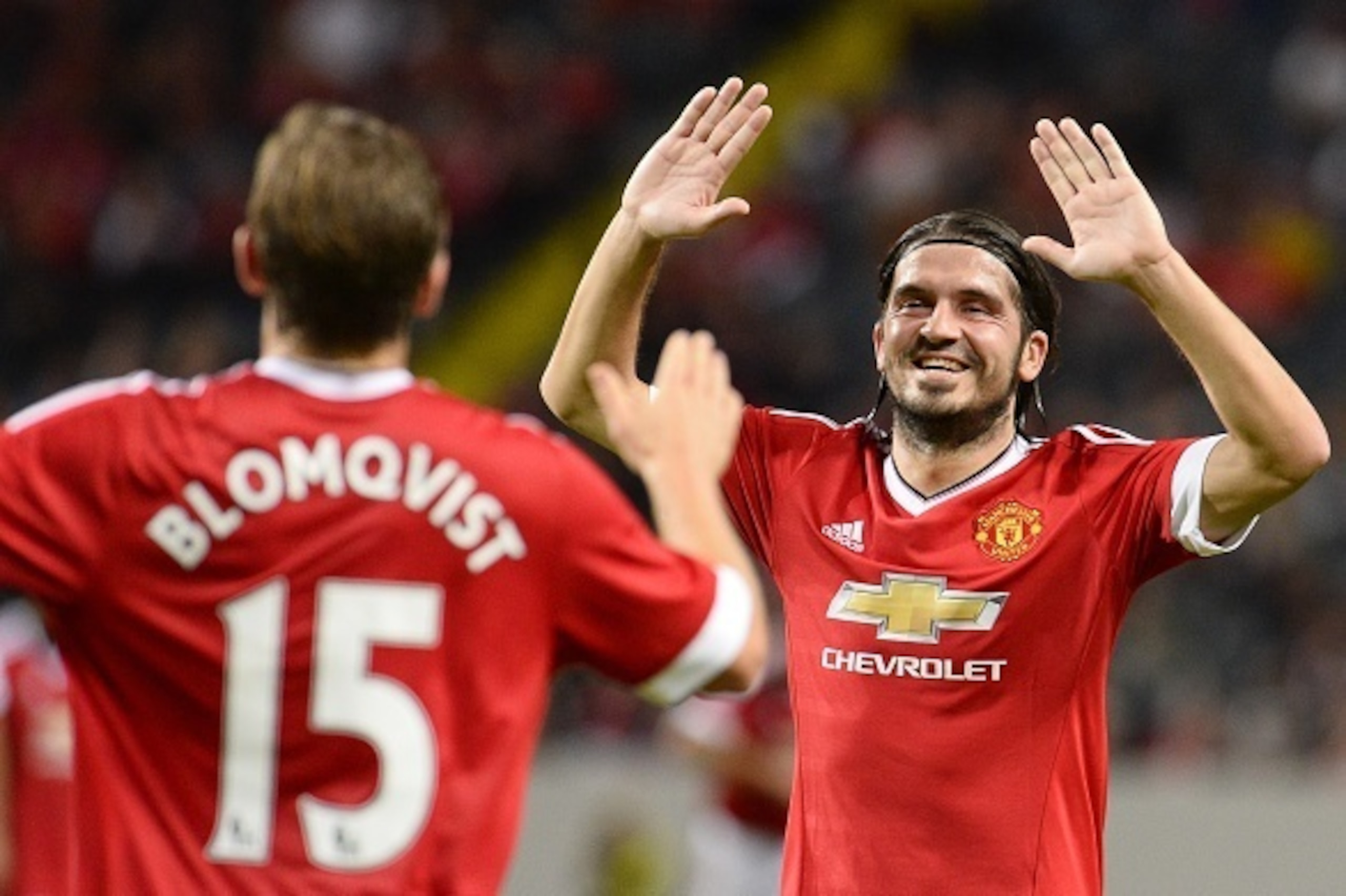 Jesper Blomqvist (L) of Manchester United celebrates with his teammate Bojan Djordjic after scoring a goal during the charity football match Manchester United Legends vs Liverpool Legends at the Friends arena in Solna, near Stockholm on September 3, 2015.