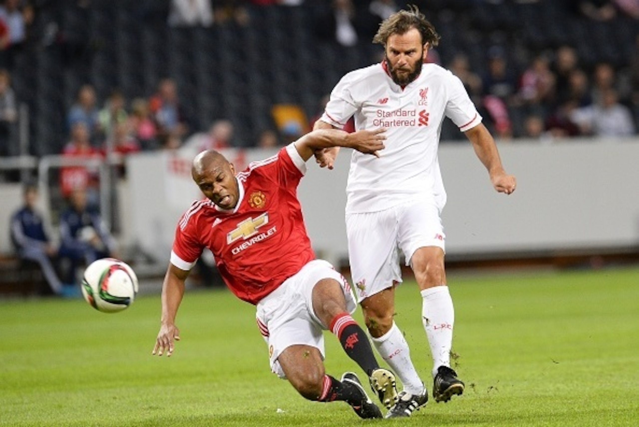 Quinton Fortunem of Manchester United vies with Patrik Berger (R) of Liverpool during the charity football match Manchester United Legends vs Liverpool Legends at the Friends arena in Solna, near Stockholm on September 3, 2015. AFP PHOTO/JONATHAN NACKSTRA
