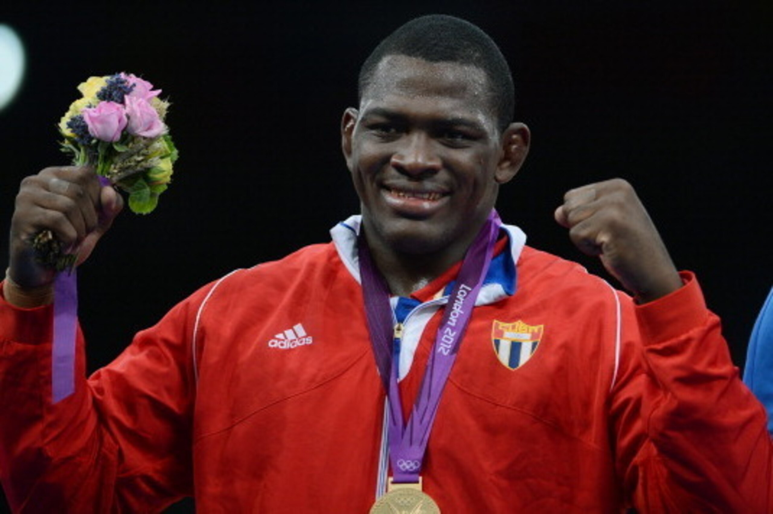 Gold Medalist Cuban Mijain Lopez Nunez poses for a photograph on the podium during the medal ceremony of the men's 120 kg greco roman style at the London 2012 Olympic Games in London on August 6, 2012. AFP PHOTO /ADEK BERRY        (Photo credit should rea