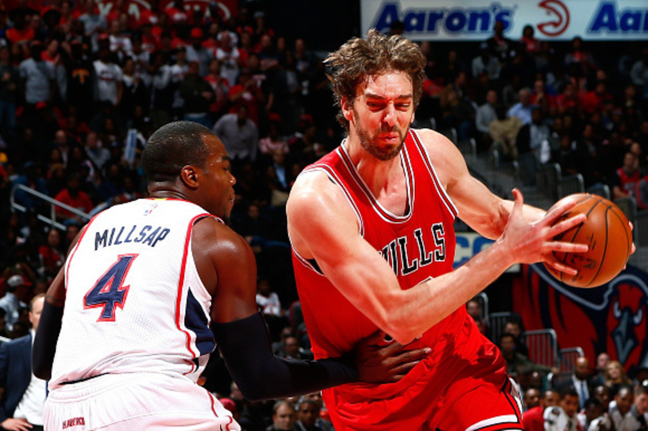 ATLANTA, GA - DECEMBER 15:  Pau Gasol #16 of the Chicago Bulls drives against Paul Millsap #4 of the Atlanta Hawks at Philips Arena on December 15, 2014 in Atlanta, Georgia.  NOTE TO USER: User expressly acknowledges and agrees that, by downloading and or