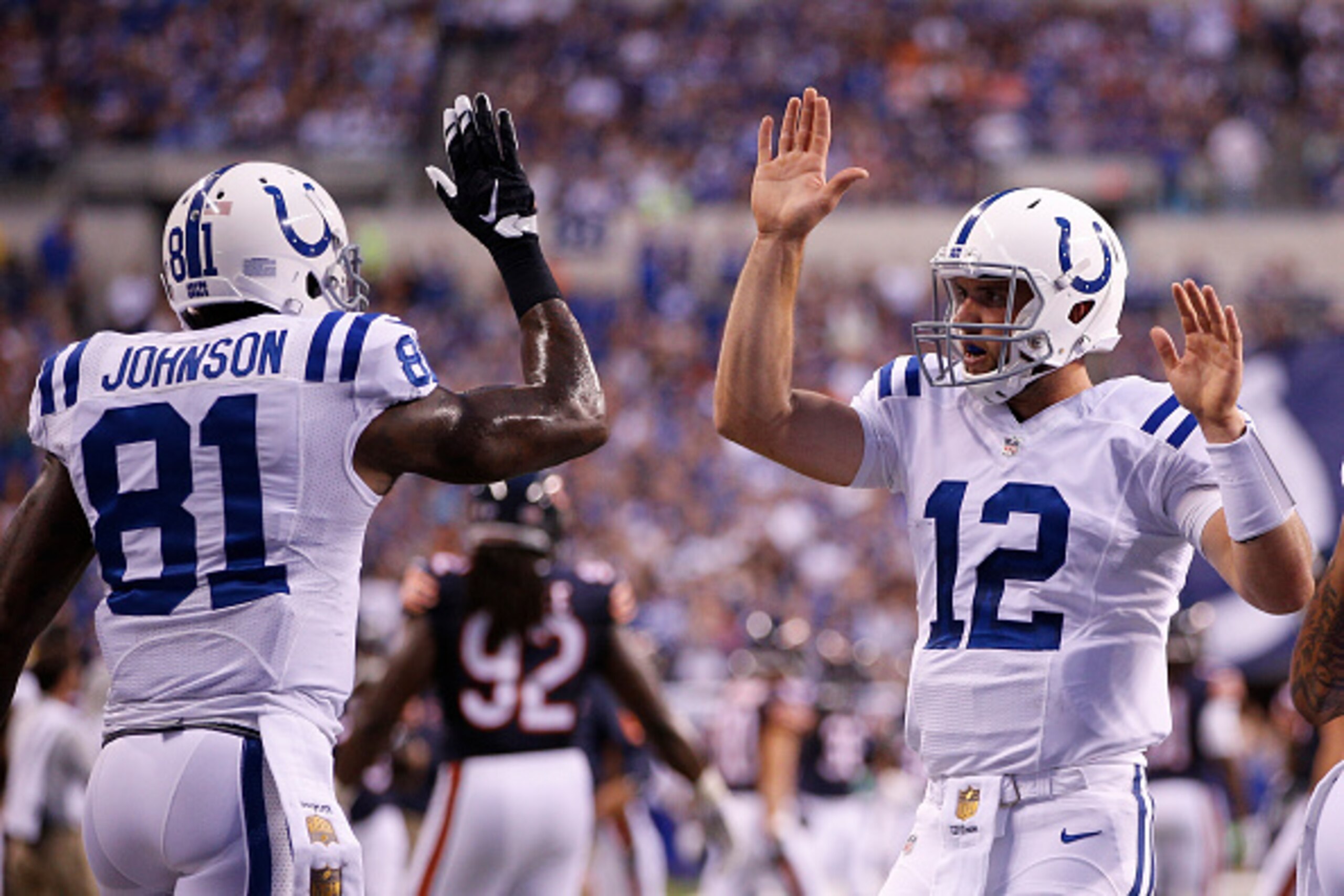 INDIANAPOLIS, IN - AUGUST 22: Andrew Luck #12 and Andre Johnson #81 of the Indianapolis Colts celebrate after connecting on a two-point conversion in the first half of a preseason game against the Chicago Bears at Lucas Oil Stadium on August 22, 2015 in I