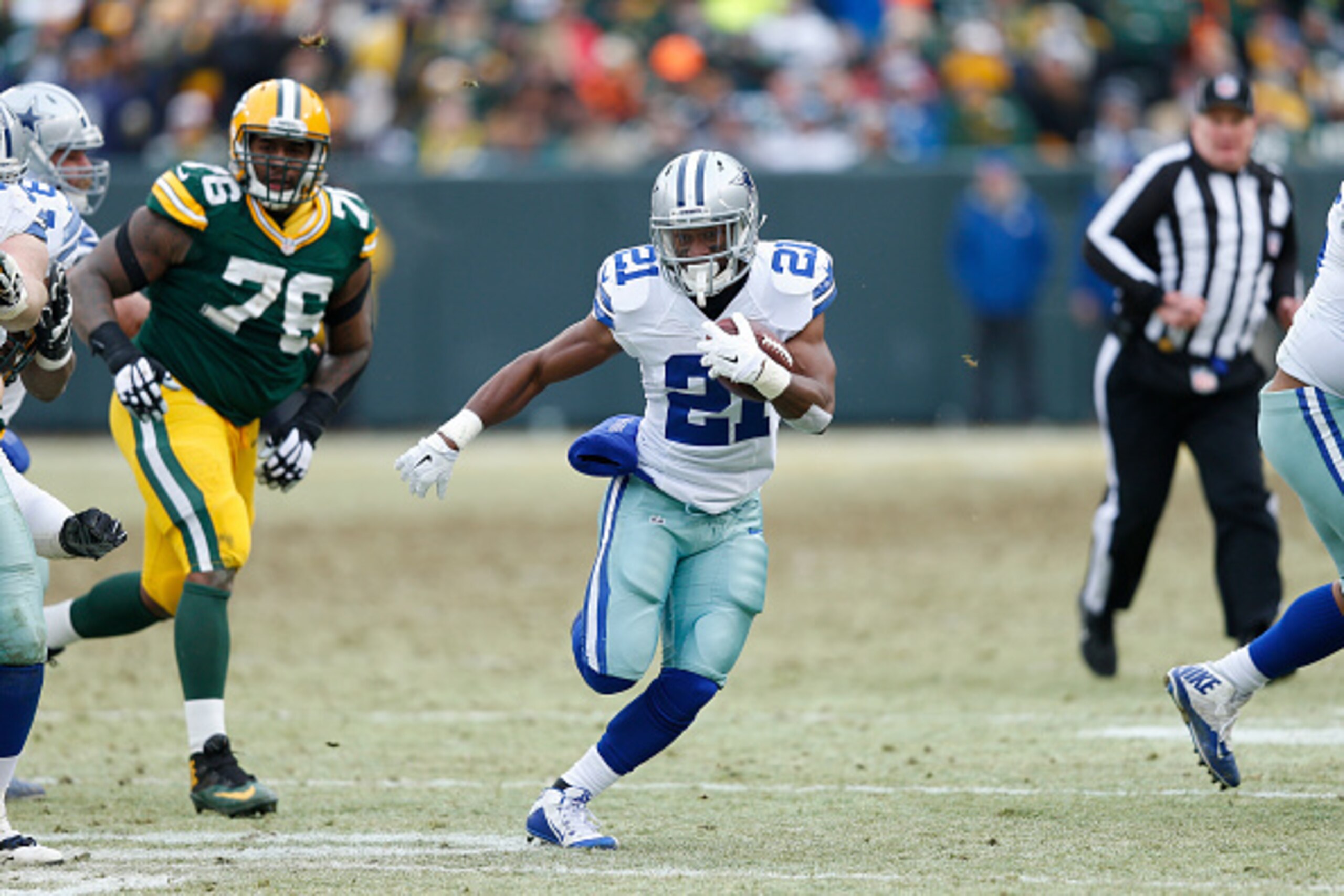GREEN BAY, WI - JANUARY 11: Joseph Randle #21 of the Dallas Cowboys runs with the ball against the Green Bay Packers during the NFC Divisional Playoff game at Lambeau Field on January 11, 2015 in Green Bay, Wisconsin. The Packers defeated the Cowboys 26-2