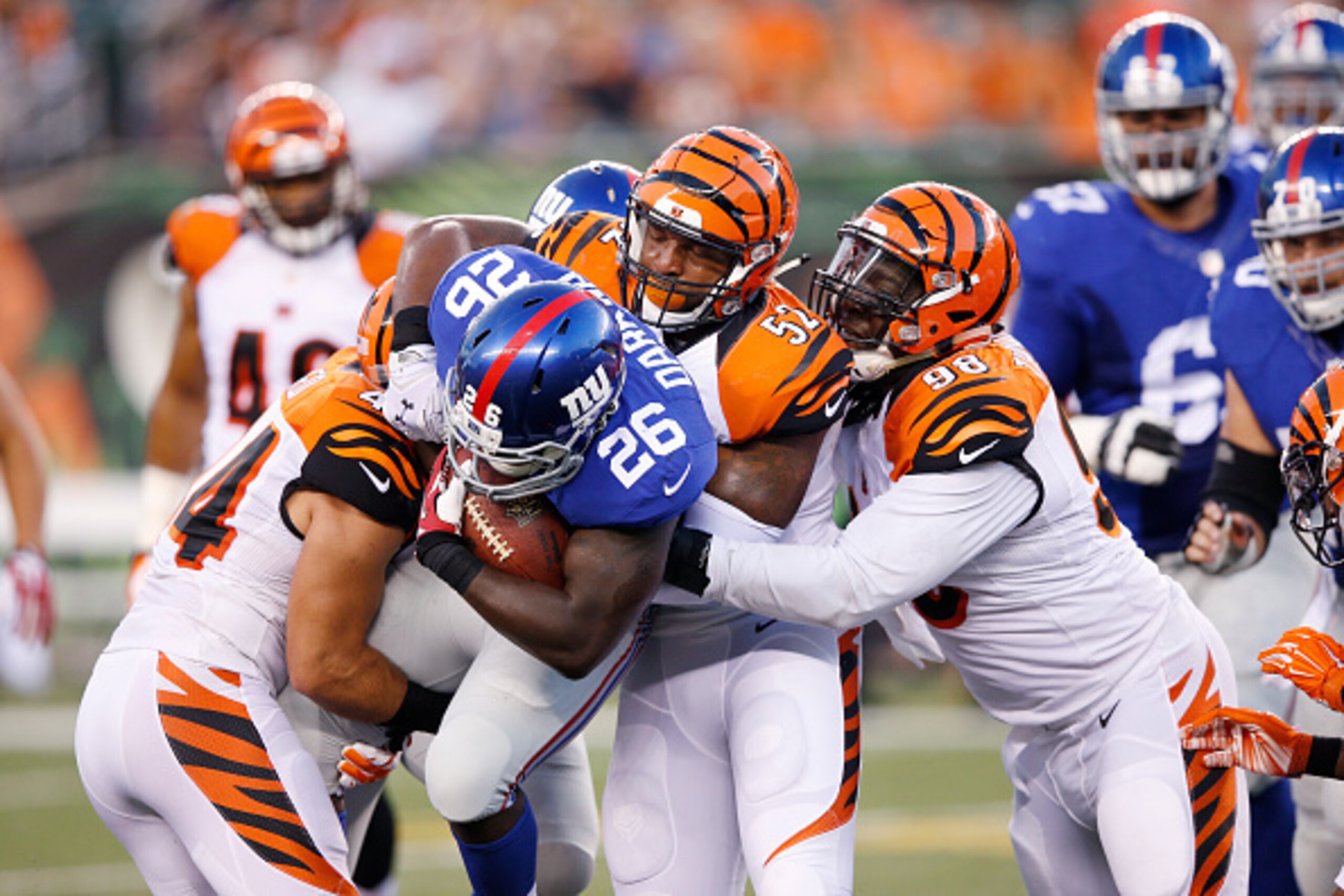 CINCINNATI, OH - AUGUST 14: Nico Johnson #52, Brandon Thompson #98 and Shiloh Keo #44 of the Cincinnati Bengals make a tackle against Orleans Darkwa #26 of the New York Giants during a preseason game at Paul Brown Stadium on August 14, 2015 in Cincinnati,