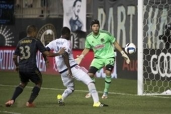 Aug 16, 2015; Philadelphia, PA, USA; Chicago Fire forward Patrick Nyarko (14) puts the ball past Philadelphia Union goalkeeper John McCarthy (55) during a game at PPL Park. The game ended in a draw 3-3. Mandatory Credit: Derik Hamilton-USA TODAY Sports