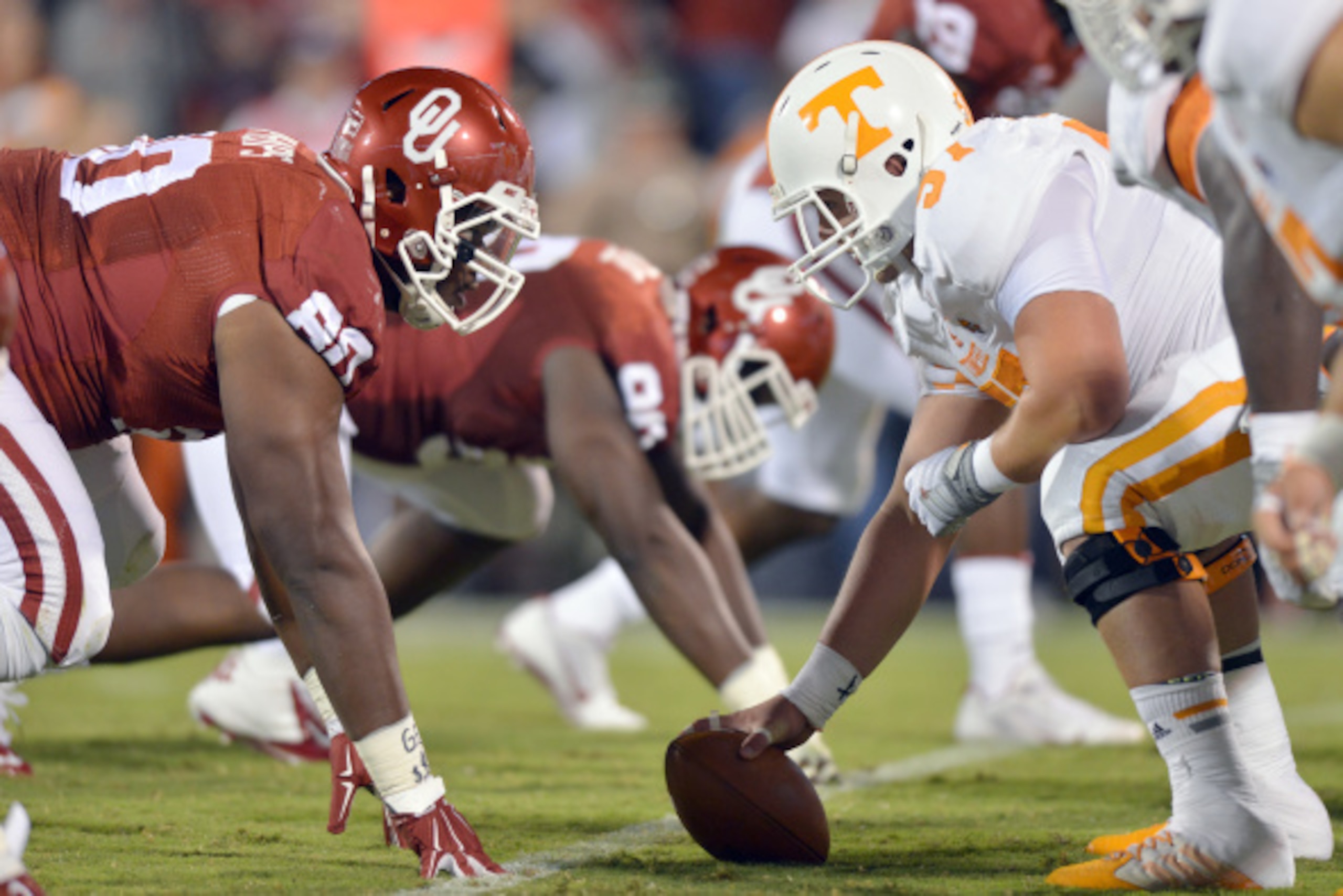 NORMAN, OK - SEPTEMBER 13: Defensive tackle Jordan Phillips #80 of the Oklahoma Sooners stares up at center Mack Crowder #57 of the Tennessee Volunters during first half action of their game on September 13, 2014 at Gaylord Family Memorial Stadium Norman,