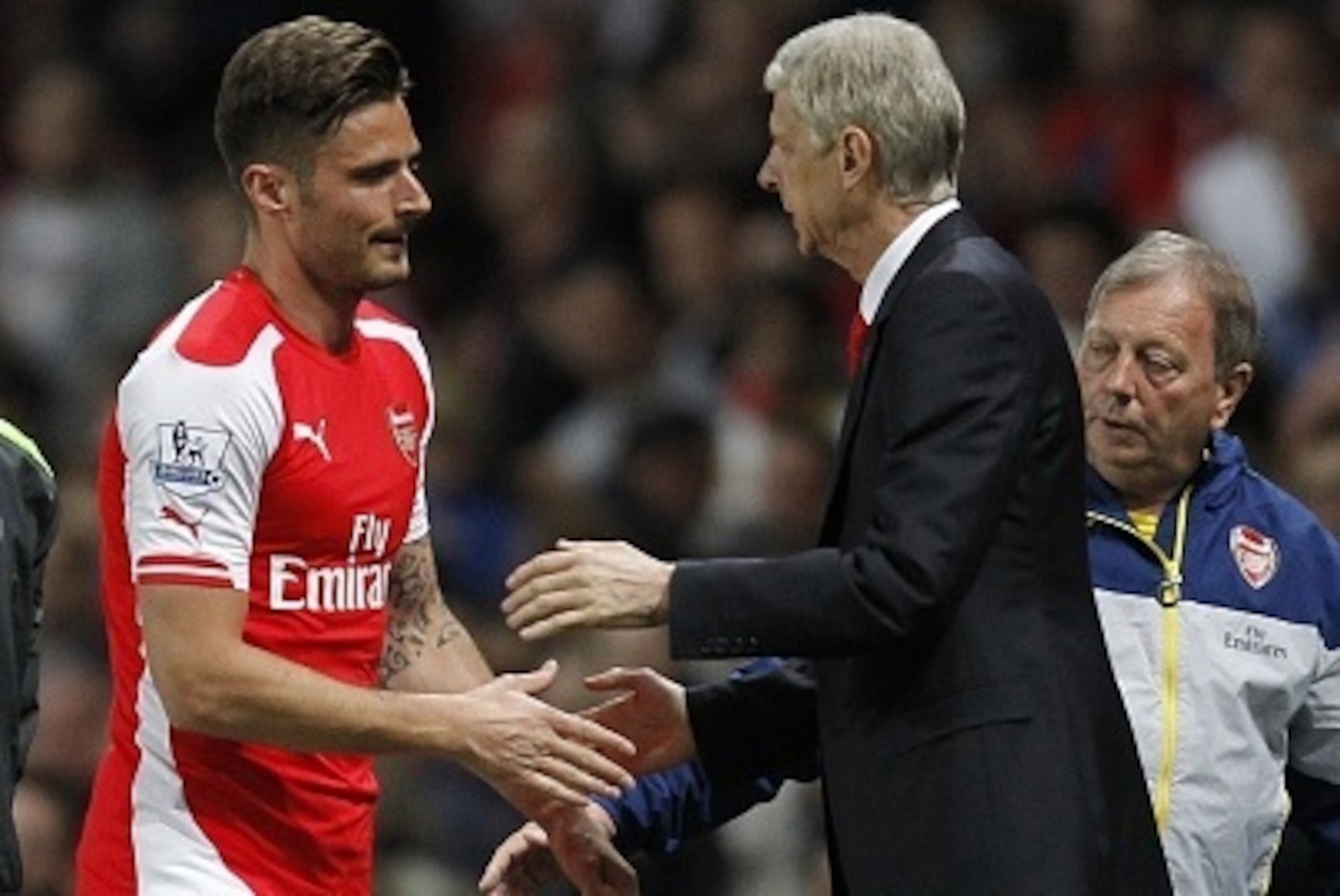 Arsenals French striker Olivier Giroud (L) shakes hands with Arsenals French manager Arsene Wenger after being substituted during the English Premier League football match between Arsenal and Swansea City at the Emirates Stadium in London on May 11, 2015.