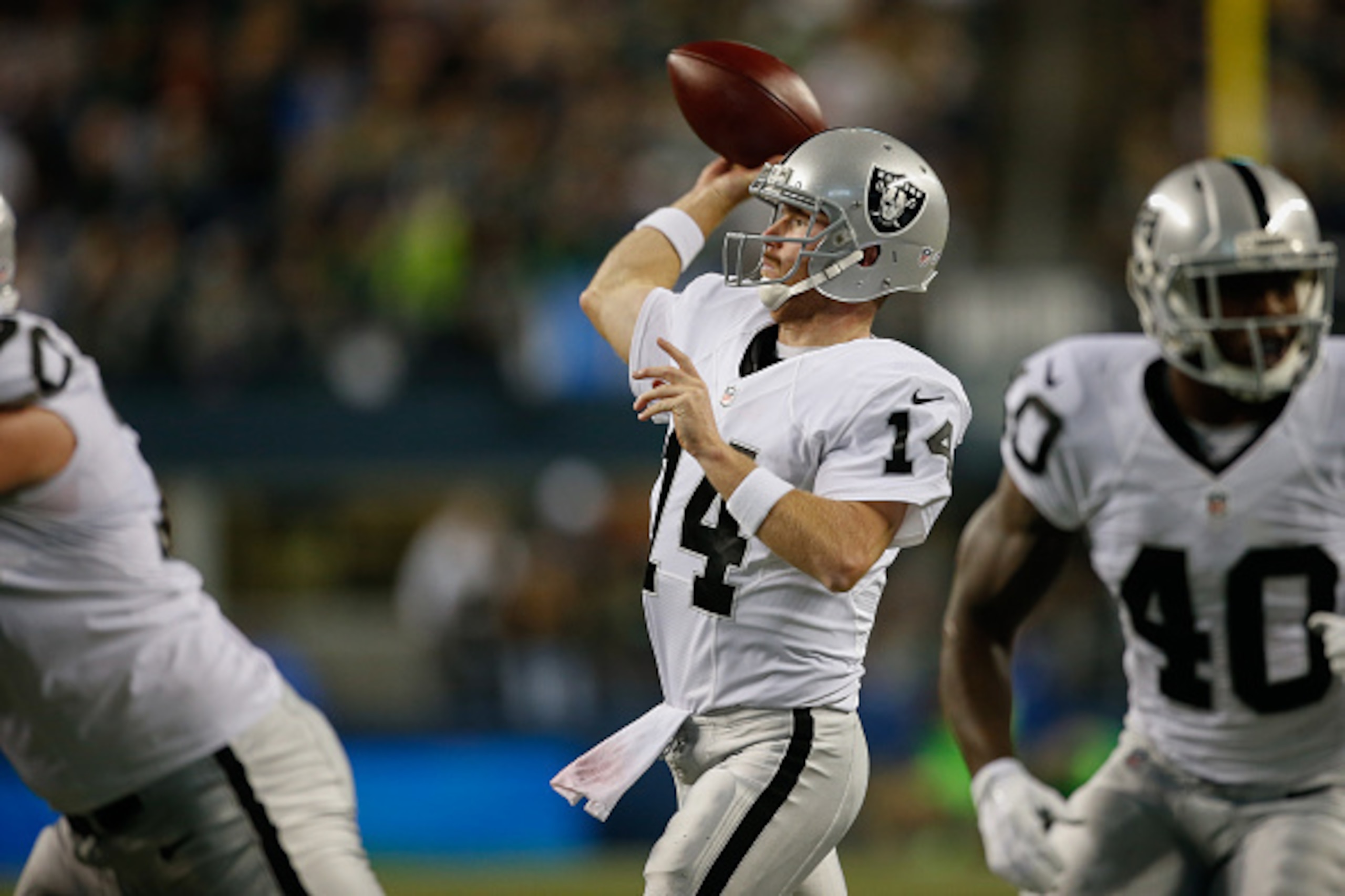 SEATTLE, WA - SEPTEMBER 03:  Quarterback Matt McGloin #14 of the Oakland Raiders throws a touchdown pass in the second quarter against the Seattle Seahawks at CenturyLink Field on September 3, 2015 in Seattle, Washington. The Seahawks defeated the Raiders