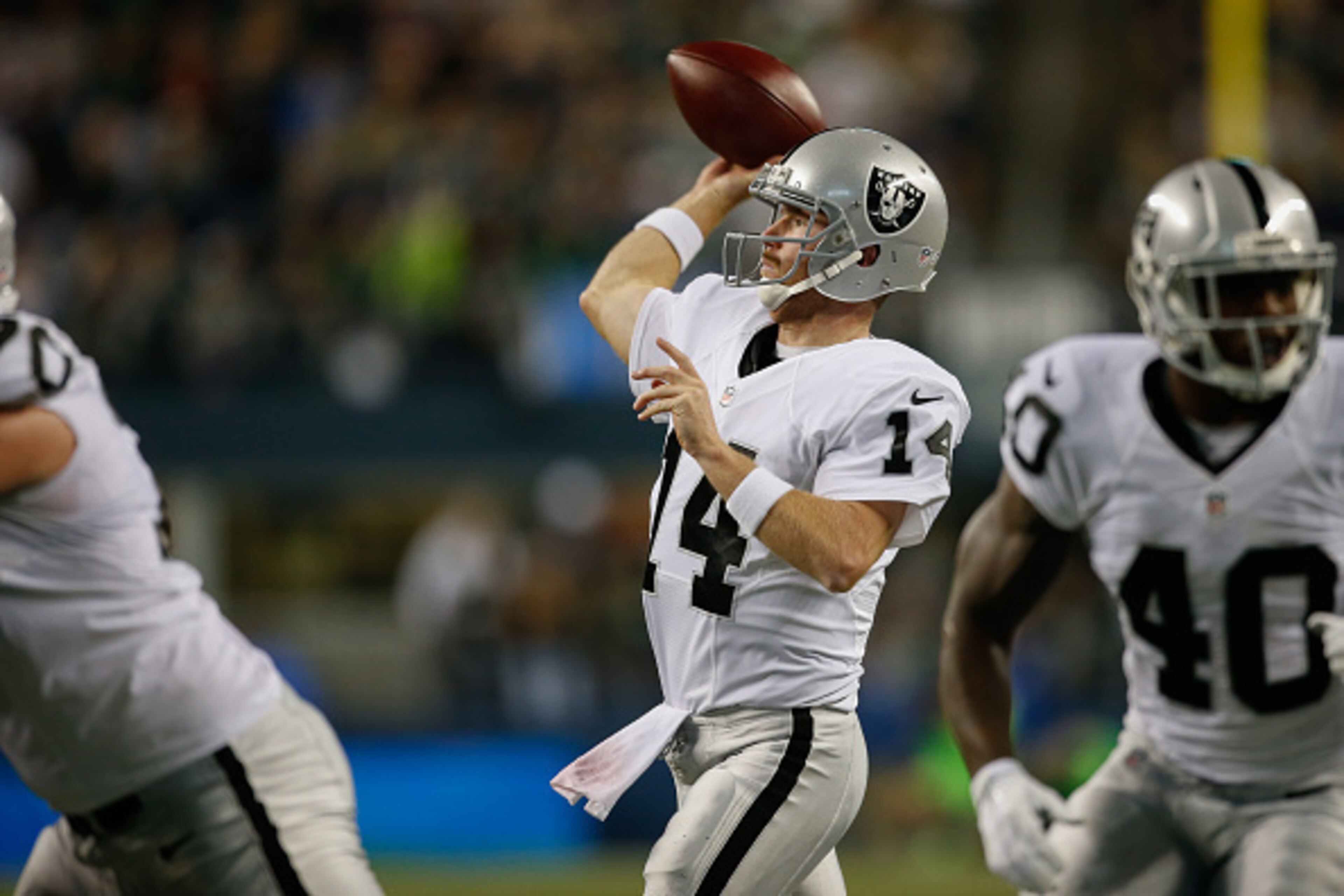 SEATTLE, WA - SEPTEMBER 03:  Quarterback Matt McGloin #14 of the Oakland Raiders throws a touchdown pass in the second quarter against the Seattle Seahawks at CenturyLink Field on September 3, 2015 in Seattle, Washington. The Seahawks defeated the Raiders
