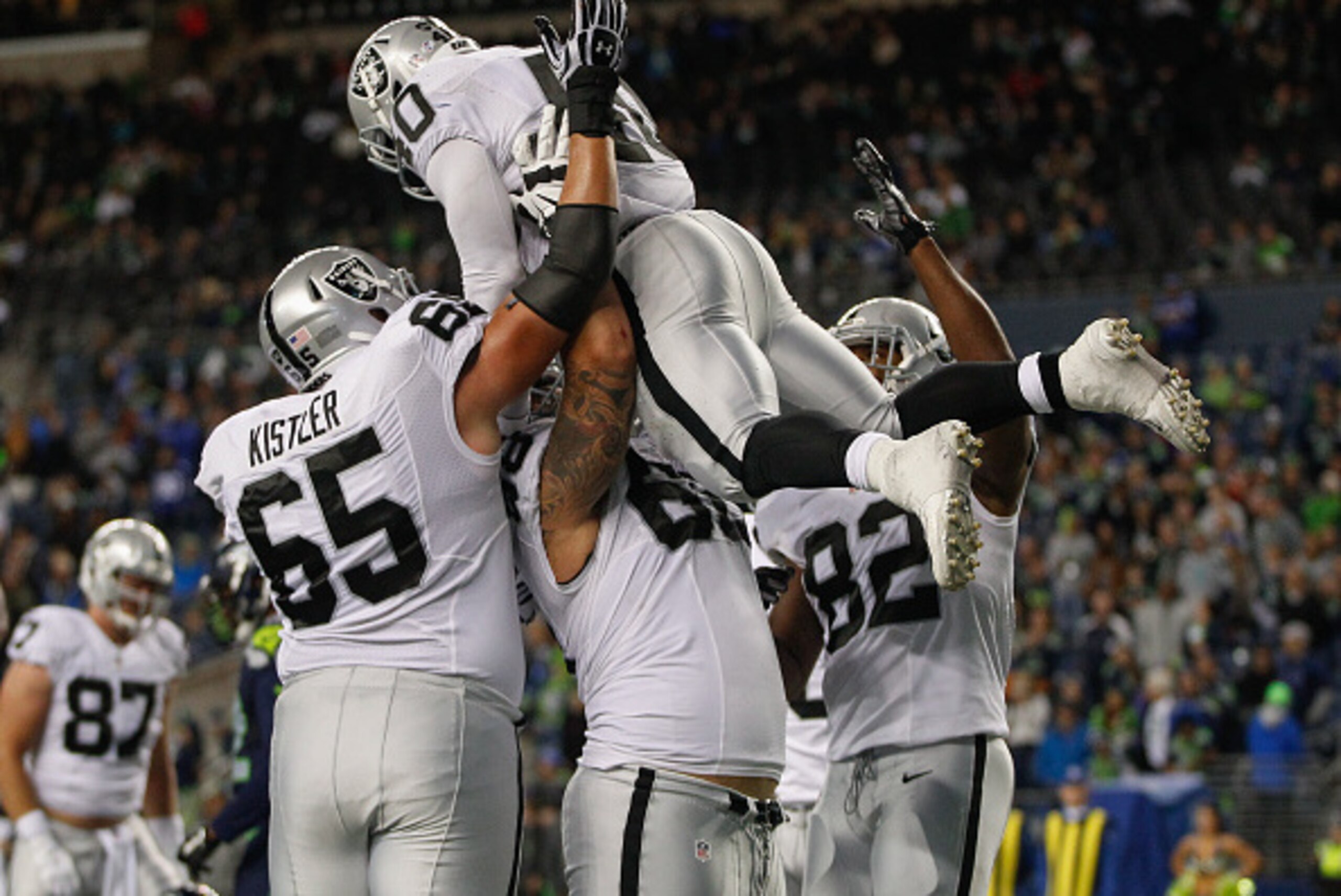 SEATTLE, WA - SEPTEMBER 03:  Running back Michael Dyer #40 of the Oakland Raiders is congratulated by teammates after scoring a touchdown against the Seattle Seahawks at CenturyLink Field on September 3, 2015 in Seattle, Washington. The Seahawks defeated 