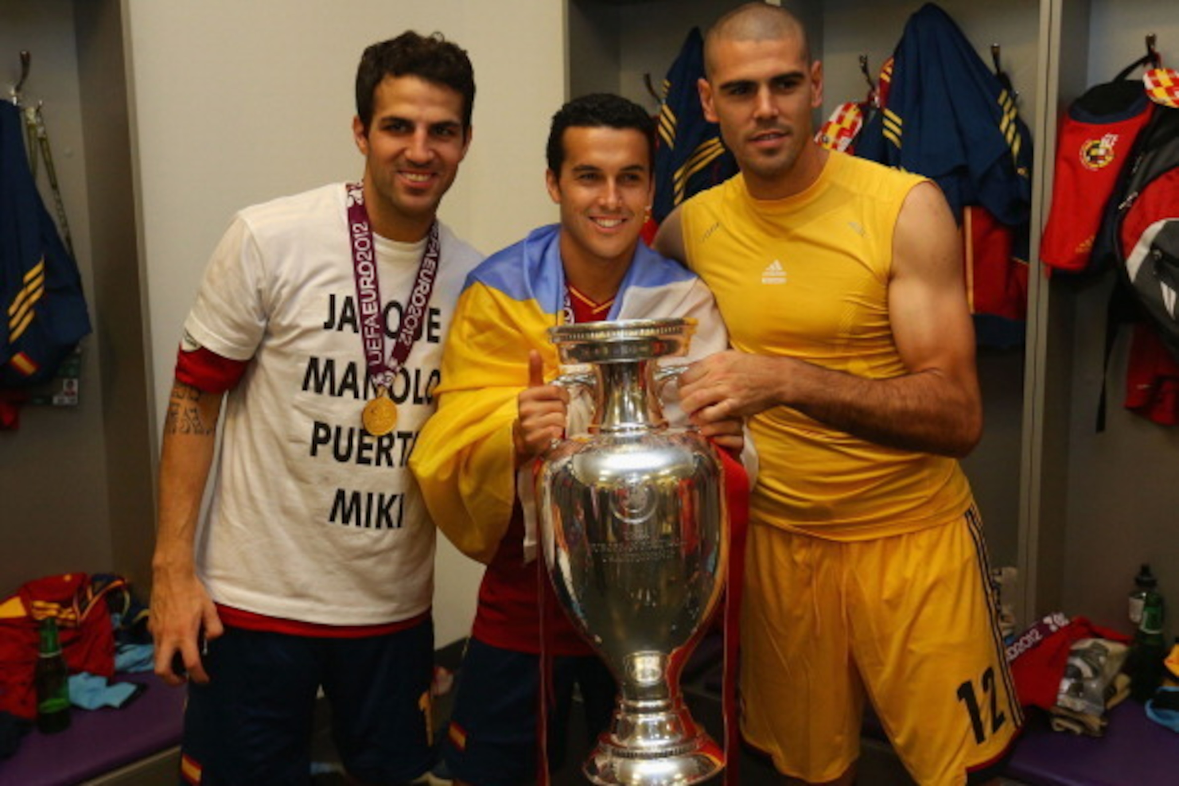 KIEV, UKRAINE - JULY 01: (L-R) Cesc Fabregas,  Pedro and Victor Valdes of Spain pose with the trophy in the dressing room following the UEFA EURO 2012 final match between Spain and Italy at the Olympic Stadium on July 1, 2012 in Kiev, Ukraine.  (Photo by 