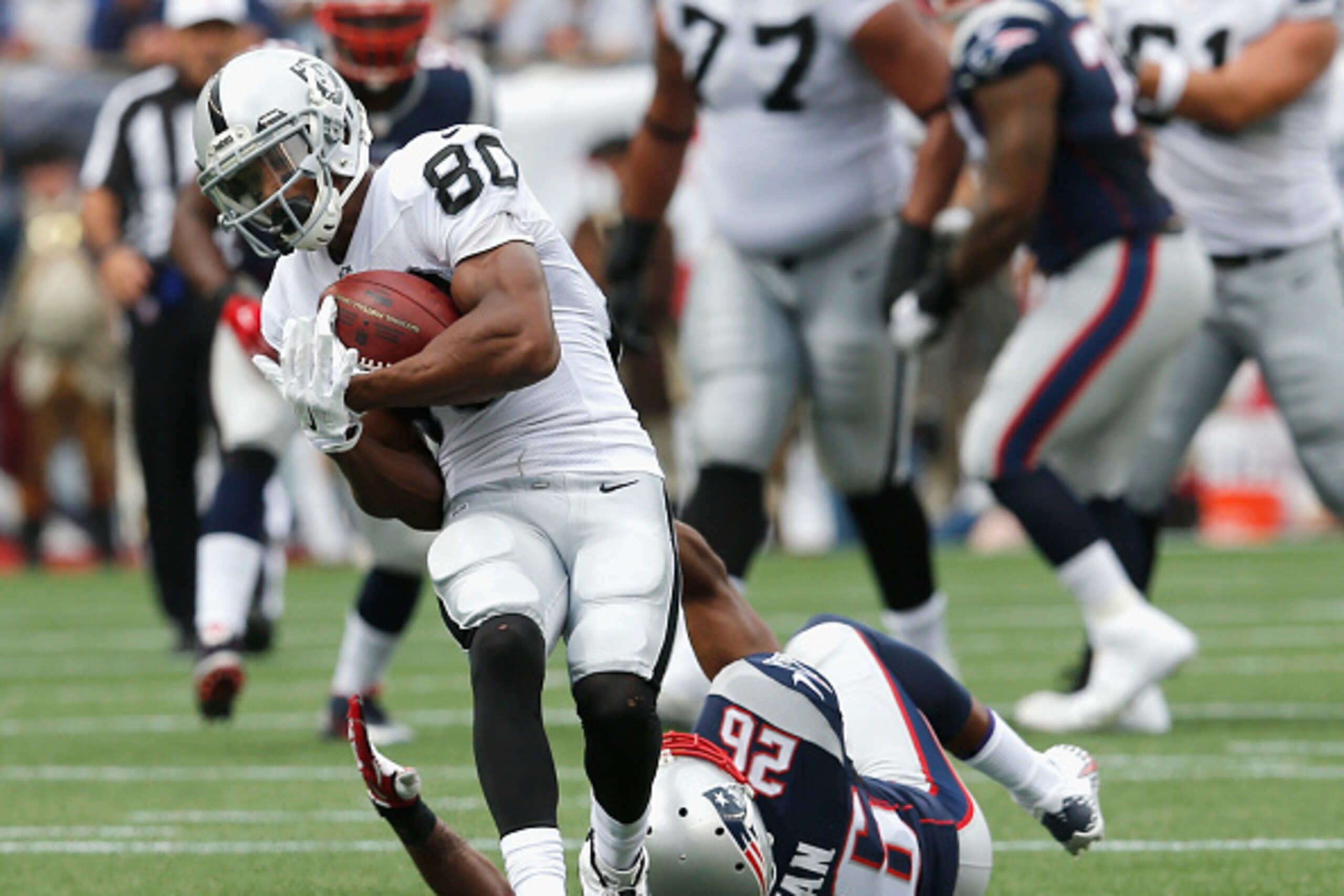 FOXBORO, MA - SEPTEMBER 21:  Rod Streater #80 of the Oakland Raiders is tackled by Logan Ryan #26 of the New England Patriots during the second quarter at Gillette Stadium on September 21, 2014 in Foxboro, Massachusetts. Streater was injured on the play. 