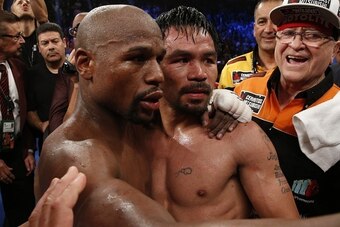 Floyd Mayweather Jr., hugs Manny Pacquiao after defeating Pacquiao in their welterweight unification bout on May 2, 2015 at the MGM Grand Garden Arena in Las Vegas, Nevada. AFP PHOTO / JOHN GURZINKSI        (Photo credit should read JOHN GURZINSKI/AFP/Get