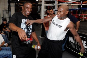 LAS VEGAS - APRIL 14:  Floyd Mayweather Sr. (L) jokes around with his son, boxer Floyd Mayweather Jr., as he works out April 14, 2010 in Las Vegas, Nevada. Mayweather is scheduled to face Shane Mosley in a 12-round welterweight bout on May 1, 2010 in Las 