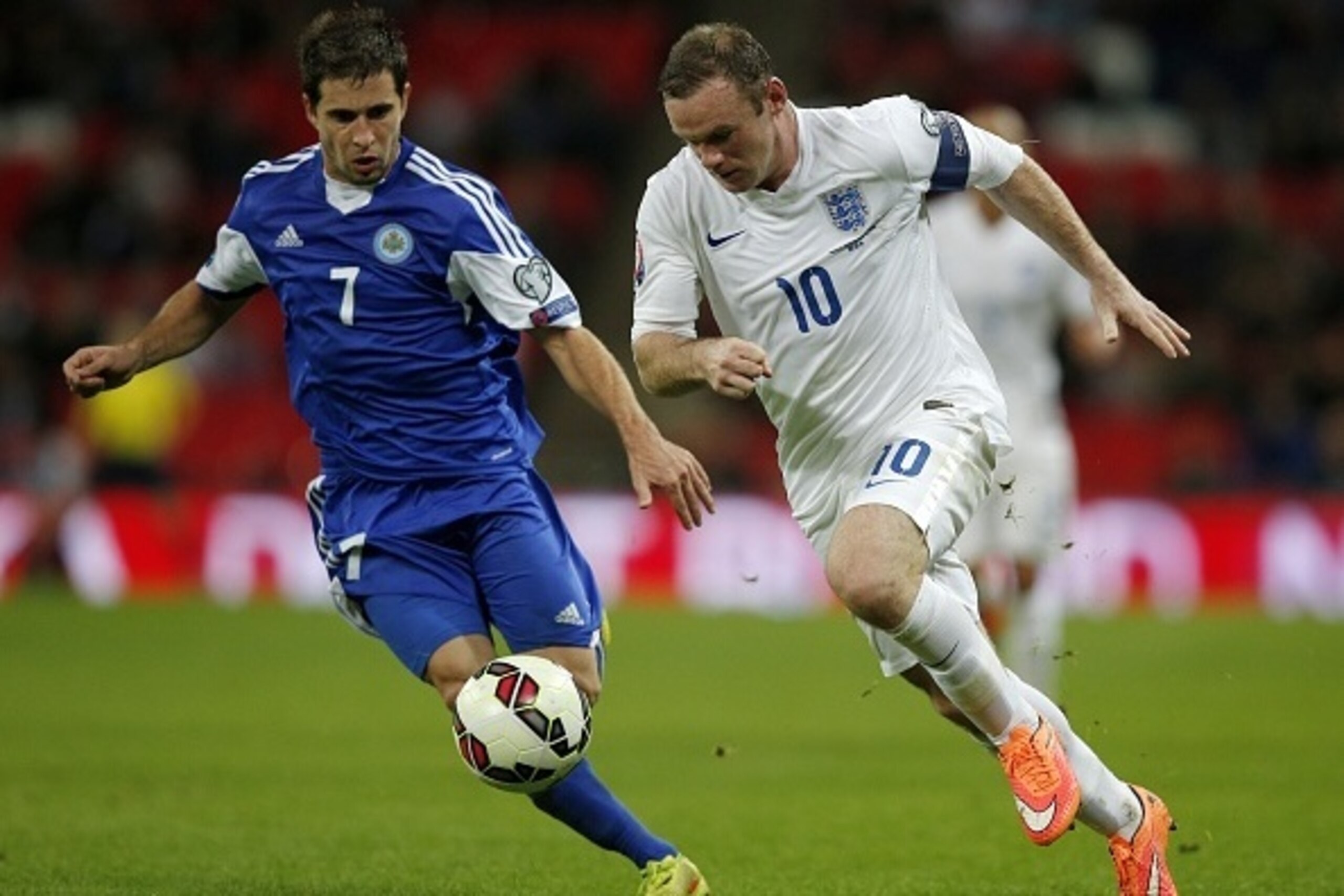 England's forward Wayne Rooney (R) vies for the ball against San Marino's Adolfo Jose Hirsch during a Euro 2016 Qualifier football match between England and San Marino at Wembley Stadium in north London, on October 9, 2014.  AFP PHOTO/ADRIAN DENNIS
NOT FO