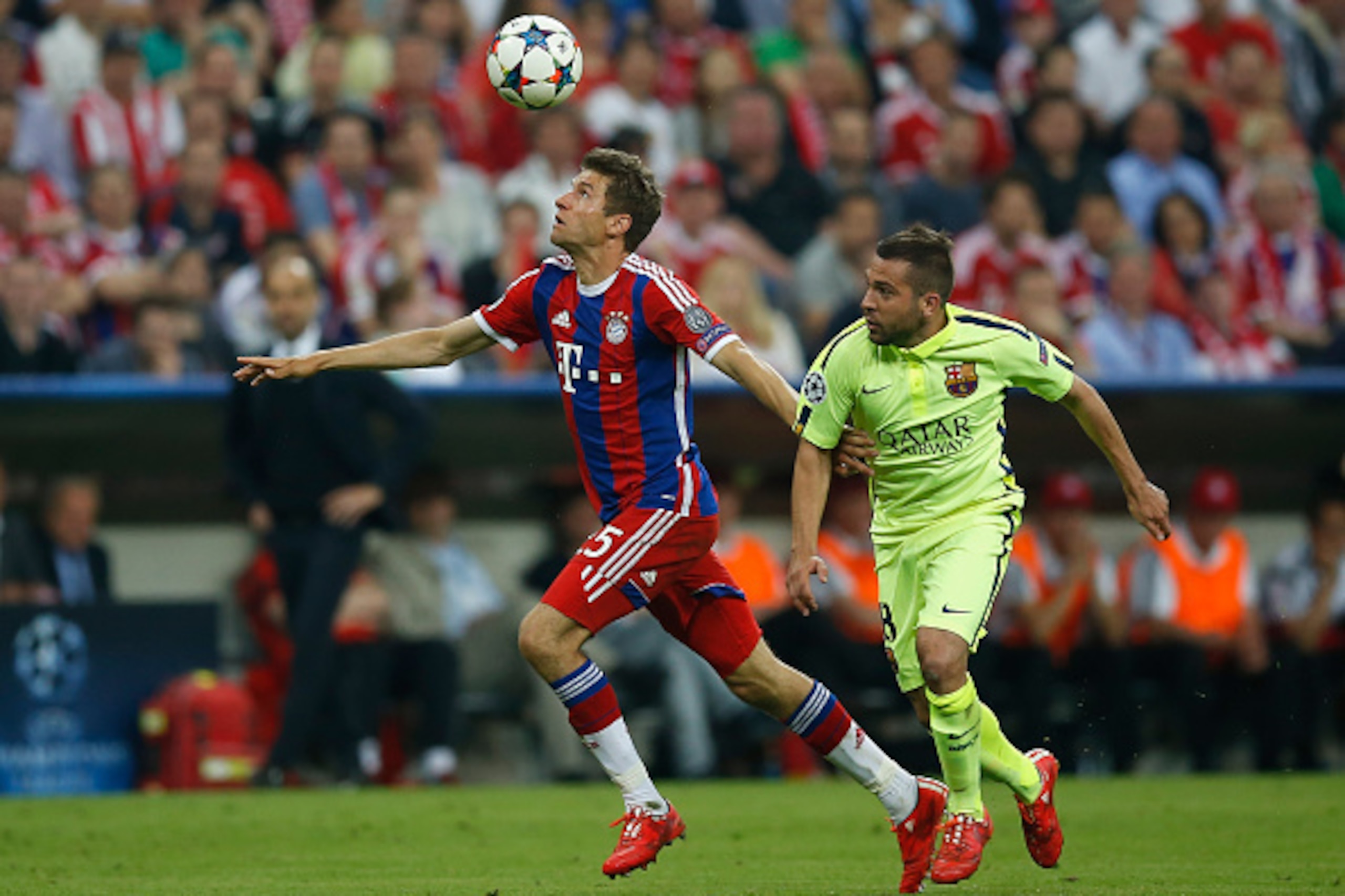 MUNICH, GERMANY - MAY 12:  Jordi Alba (R) of Barcelona challenges Thomas Mueller of Bayern Muenchen during the UEFA Champions League semi final second leg match between FC Bayern Muenchen and FC Barcelona at Allianz Arena on May 12, 2015 in Munich, German