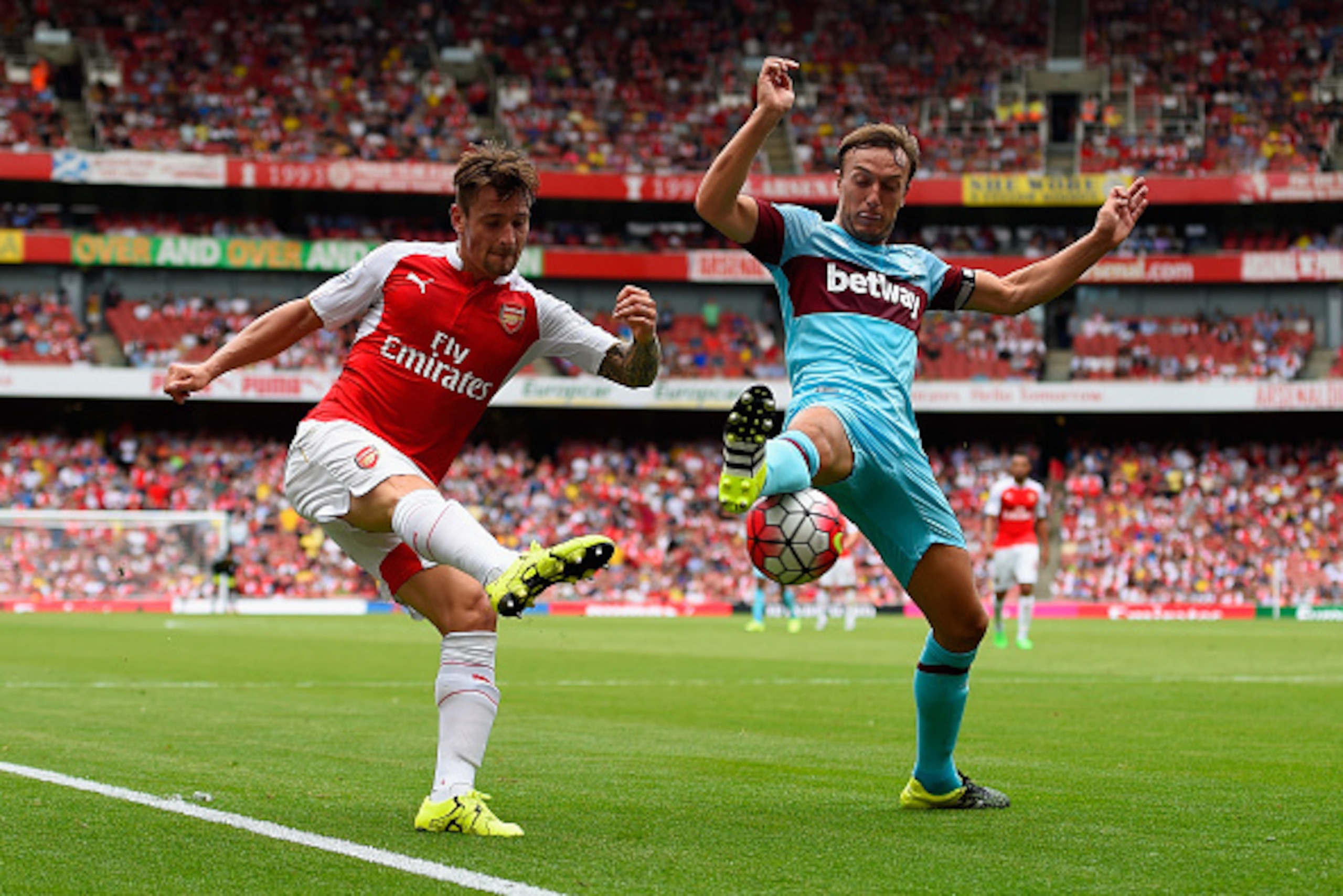 LONDON, ENGLAND - AUGUST 09:  Mathieu Debuchy of Arsenal is put under pressure by Mark Noble of West Ham United  during the Barclays Premier League match between Arsenal and West Ham United at the Emirates Stadium on August 9, 2015 in London, England.  (P