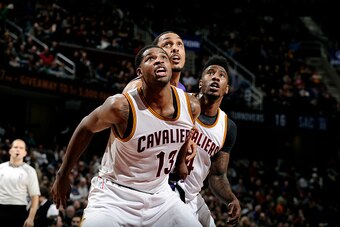 CLEVELAND, OH - JANUARY 30: Tristan Thompson #13 and Iman Shumpert #4 of the Cleveland Cavaliers battle for position against Ryan Hollins #5 of the Sacramento Kings at The Quicken Loans Arena on January 30, 2015 in Cleveland, Ohio. NOTE TO USER: User expr