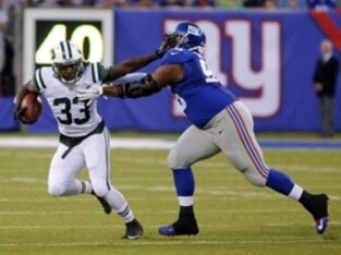 Aug 29, 2015; East Rutherford, NJ, USA; New York Jets running back Chris Ivory (33) stiff arms New York Giants defensive tackle Jay Bromley (96) during the first half at MetLife Stadium. Mandatory Credit: Noah K. Murray-USA TODAY Sports