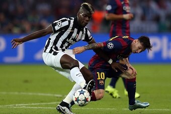 BERLIN, GERMANY - JUNE 6: Paul Pogba of Juventus in action with Lionel Messi of FC Barcelona during the UEFA Champions League Final match between Juventus and FC Barcelona at the Olympiastadion on June 6, 2015 in Berlin, Germany. (Photo by Chris Brunskill