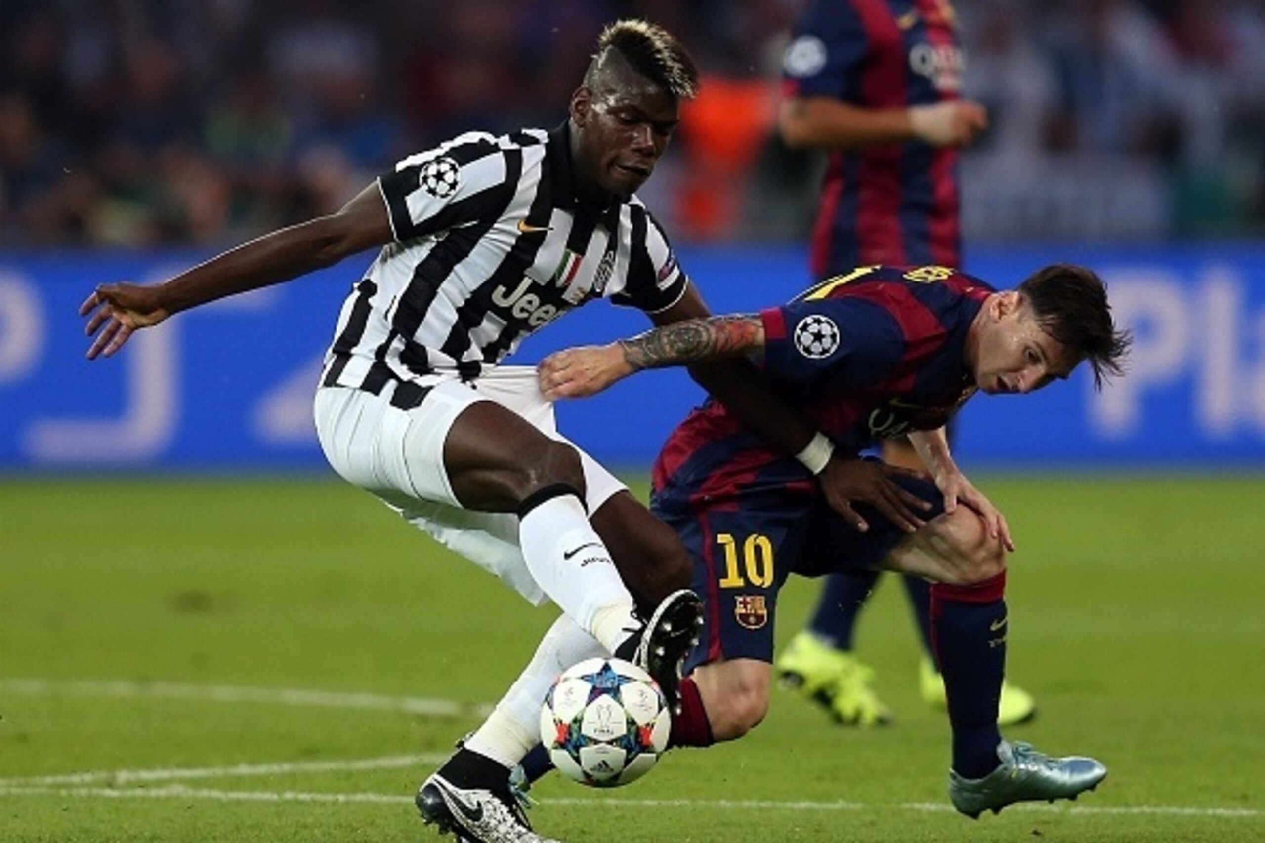 BERLIN, GERMANY - JUNE 6: Paul Pogba of Juventus in action with Lionel Messi of FC Barcelona during the UEFA Champions League Final match between Juventus and FC Barcelona at the Olympiastadion on June 6, 2015 in Berlin, Germany. (Photo by Chris Brunskill