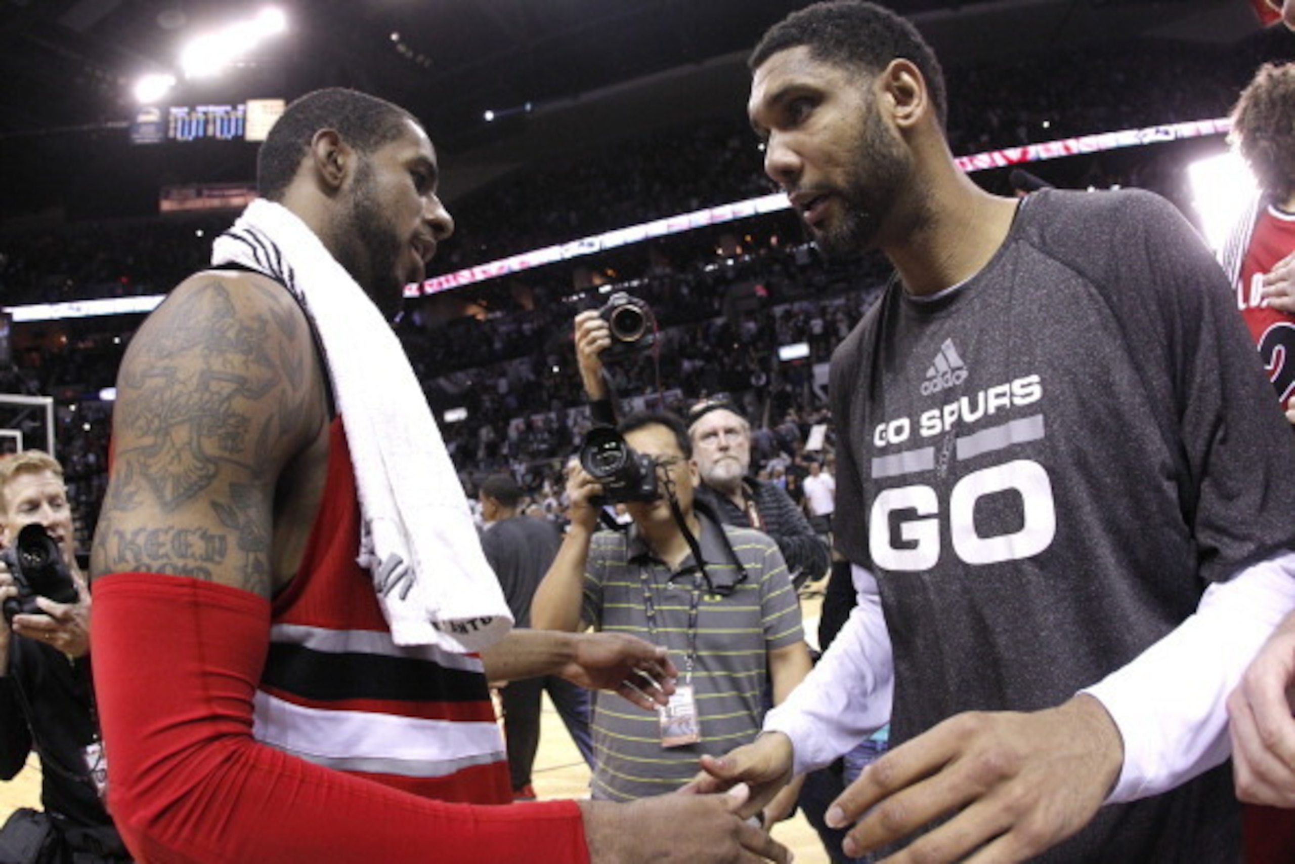 SAN ANTONIO, TX - MAY 14:  Tim Duncan #21 of the San Antonio Spurs and LaMarcus Aldridge #12 of the Portland Trail Blazers shake hands after the Spurs defeat the Trail Blazers 104-82 in Game Five of the Western Conference Semifinals during the 2014 NBA Pl
