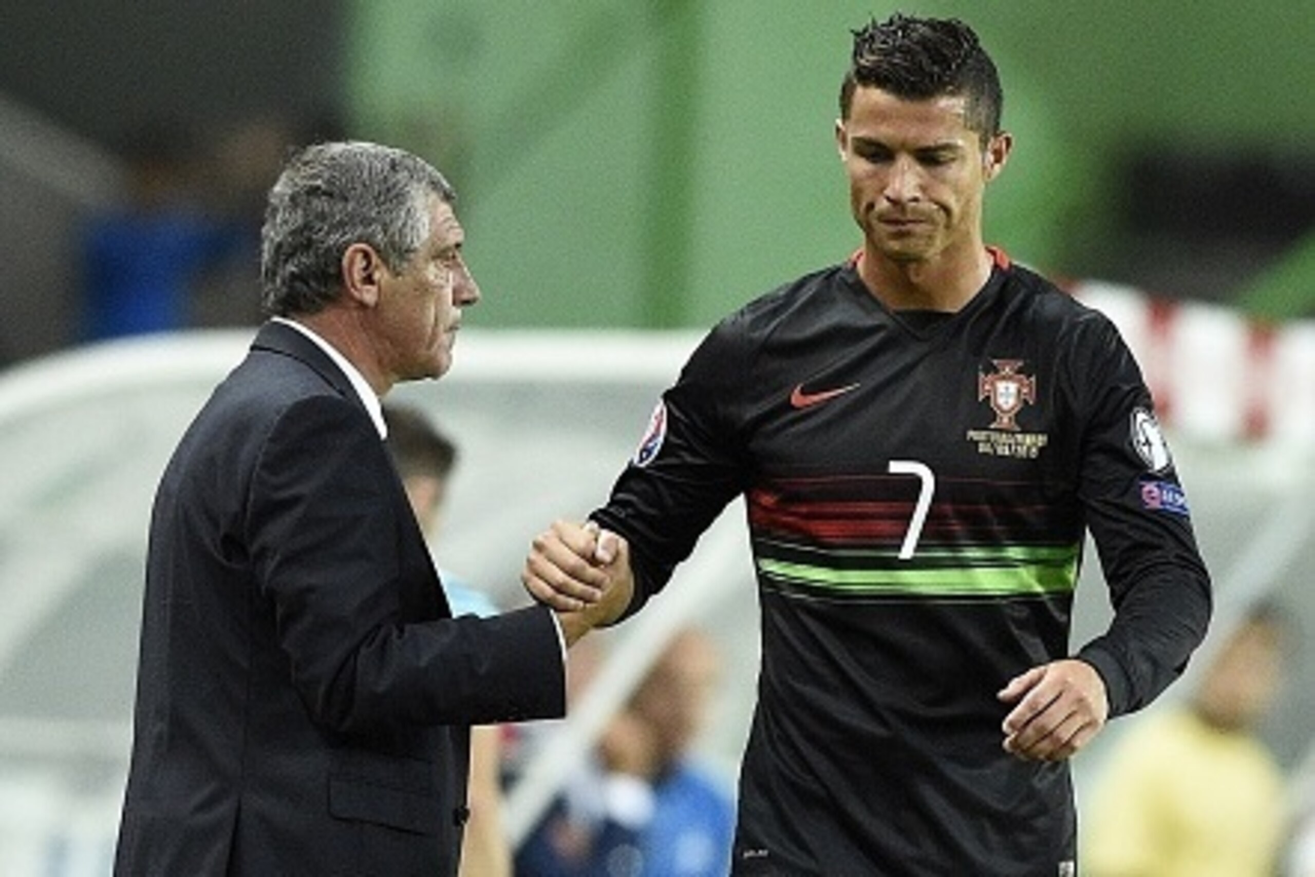 Portugal's head coach Fernando Santos (L) shakes hands of Portugal's forward Cristiano Ronaldo during the Euro 2016 friendly football match Portugal vs France at the Jose Alvalade stadium in Lisbon on September 4, 2015.   AFP PHOTO/ FRANCK FIFE        (Ph