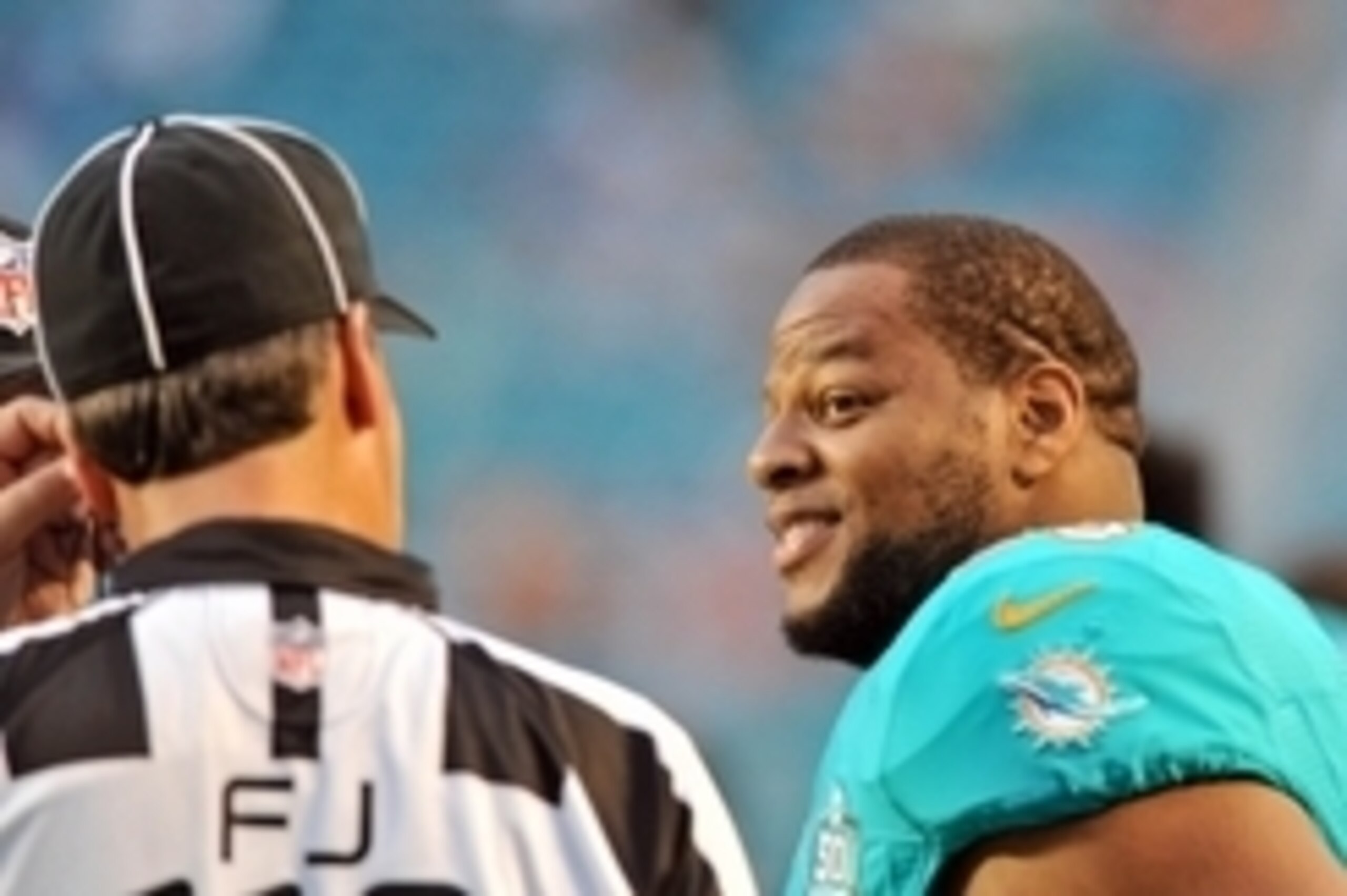 Sep 3, 2015; Miami Gardens, FL, USA; Miami Dolphins defensive tackle Ndamukong Suh (right) talks with NFL field judge Dave Meslow (left) before a game against the Tampa Bay Buccaneers at Sun Life Stadium. Mandatory Credit: Steve Mitchell-USA TODAY Sports