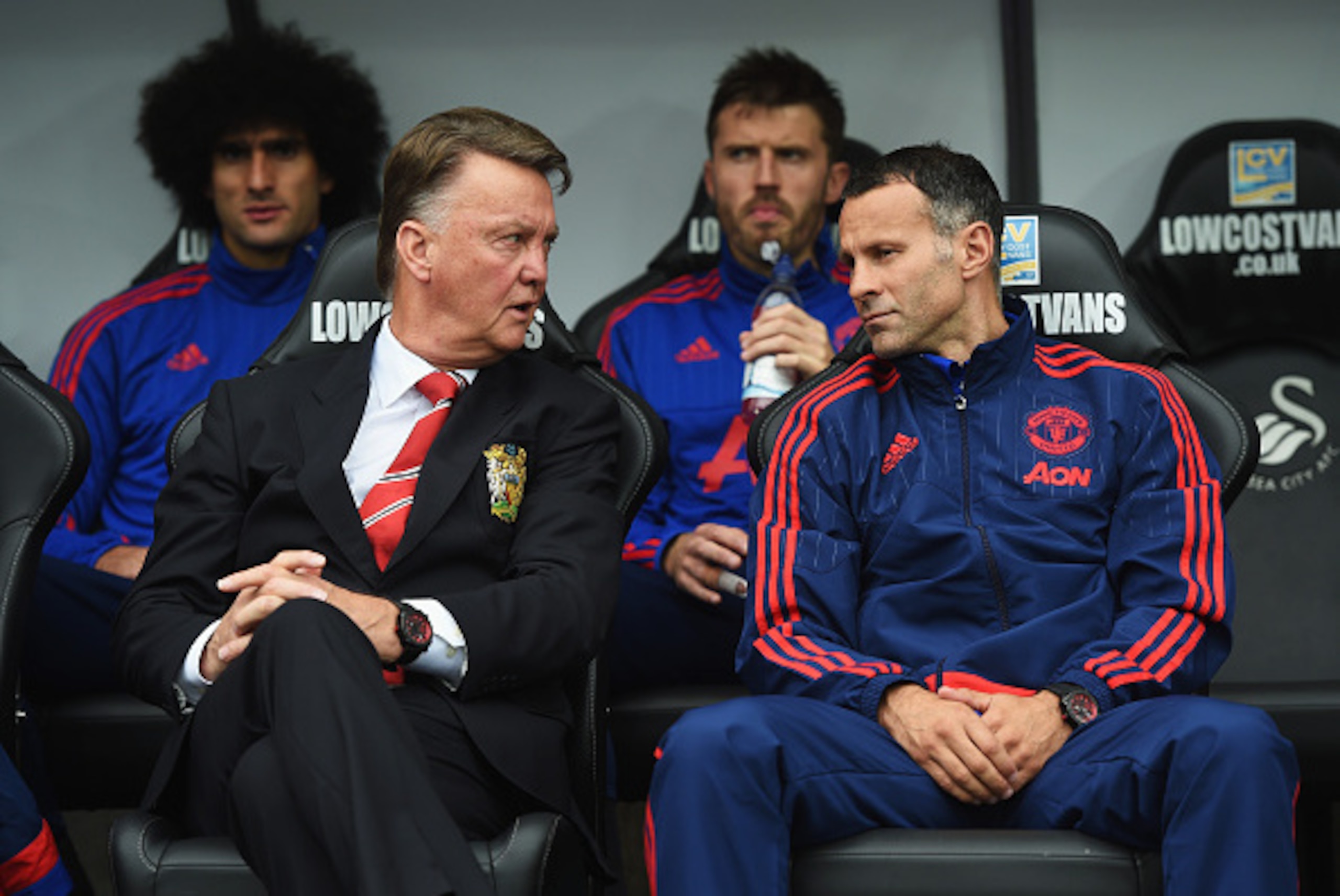 SWANSEA, WALES - AUGUST 30:  Louis van Gaal, manager of Manchester United talks to assistant Ryan Giggs during the Barclays Premier League match between Swansea City and Manchester United at Liberty Stadium on August 30, 2015 in Swansea, Wales.  (Photo by
