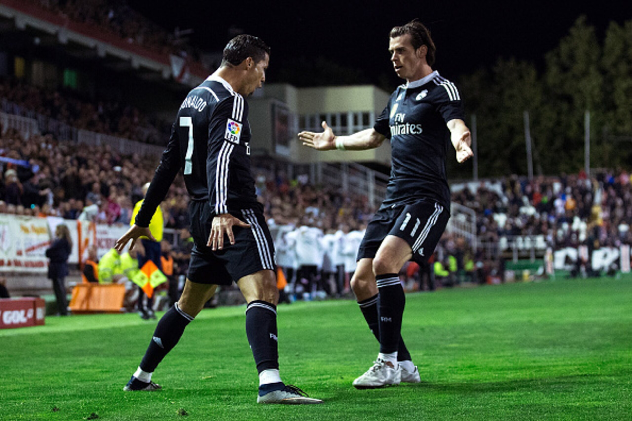 MADRID, SPAIN - APRIL 08:  Cristiano Ronaldo (L) of Real Madrid CF celebrates scoring their opening goal with teammate Gareth Bale (R) during the La Liga match between Rayo Vallecano de Madrid and Real Madrid CF at Vallecas Stadium on April 8, 2015 in Mad