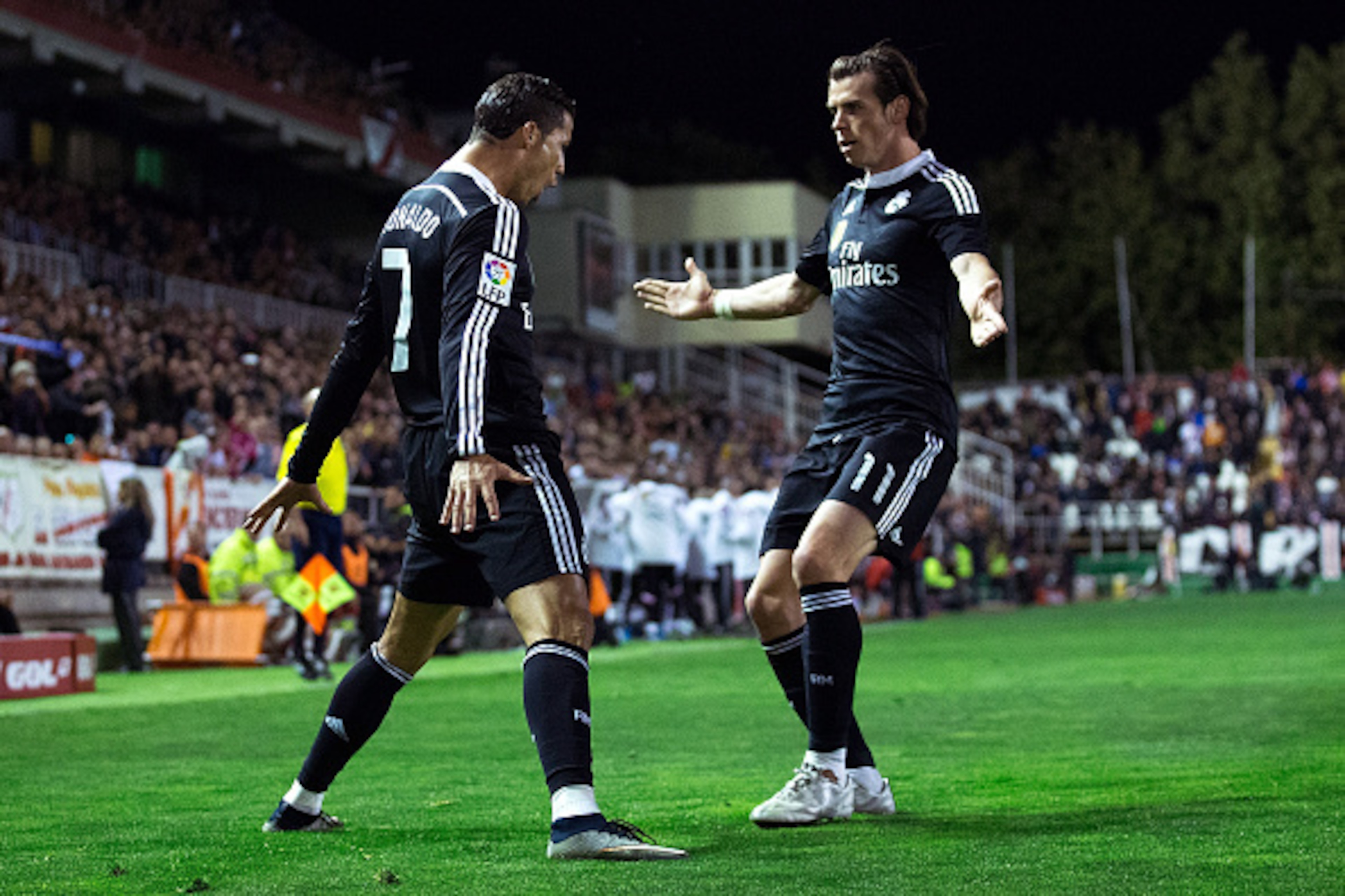 MADRID, SPAIN - APRIL 08:  Cristiano Ronaldo (L) of Real Madrid CF celebrates scoring their opening goal with teammate Gareth Bale (R) during the La Liga match between Rayo Vallecano de Madrid and Real Madrid CF at Vallecas Stadium on April 8, 2015 in Mad