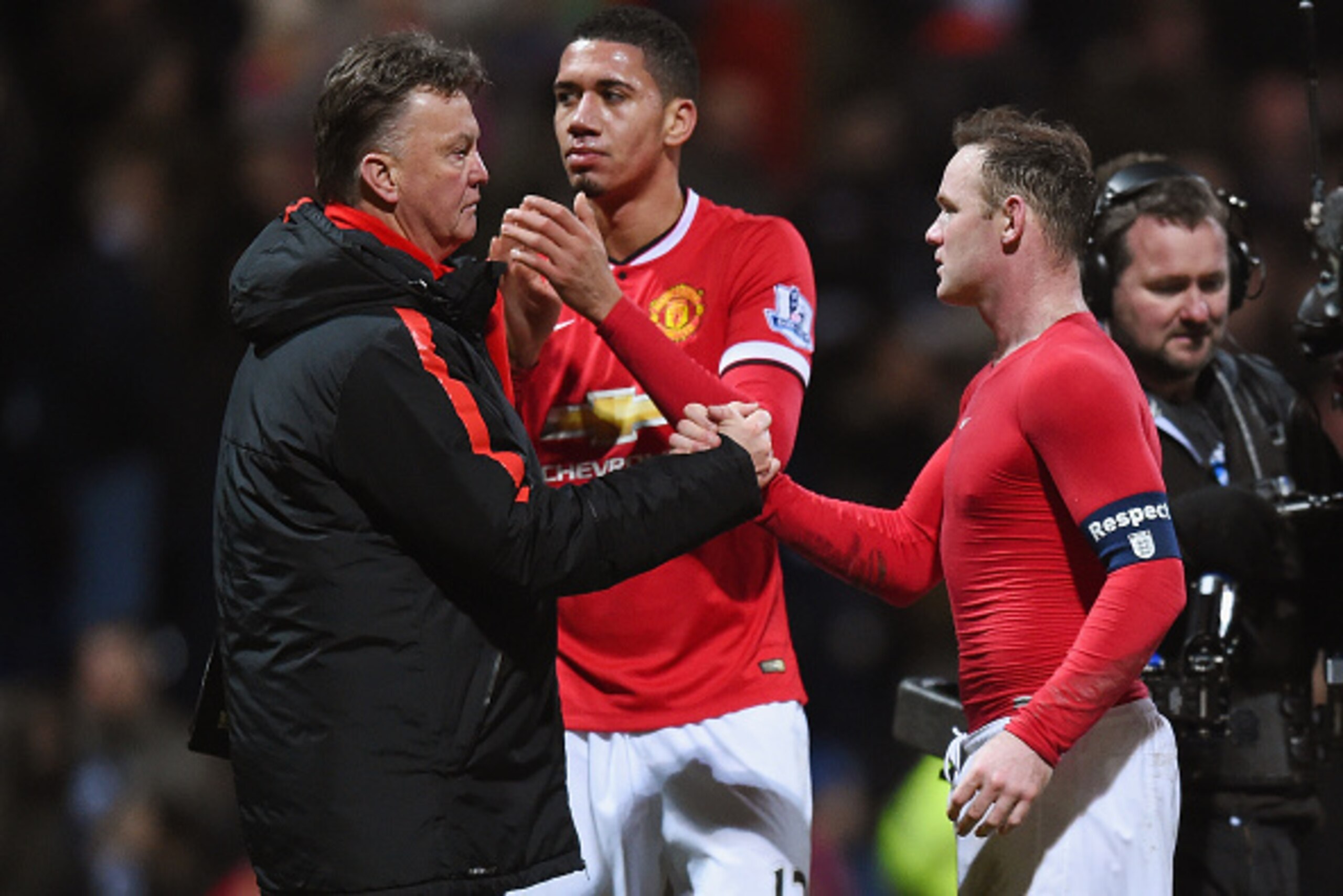 PRESTON, ENGLAND - FEBRUARY 16: Manager Louis van Gaal of Manchester United shakes hands with Wayne Rooney of Manchester United after victory in  the FA Cup Fifth round match between Preston North End and Manchester United at Deepdale on February 16, 2015