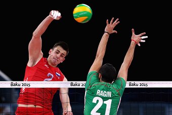 BAKU, AZERBAIJAN - JUNE 20:  IIia Vlasov of Russian Federation spikes the ball as Ventsislav Ragin of Bulgaria attempts to block in the Volleyball Men Preliminary - Pool B match during day eight of the Baku 2015 European Games at the Crystal Hall on June 