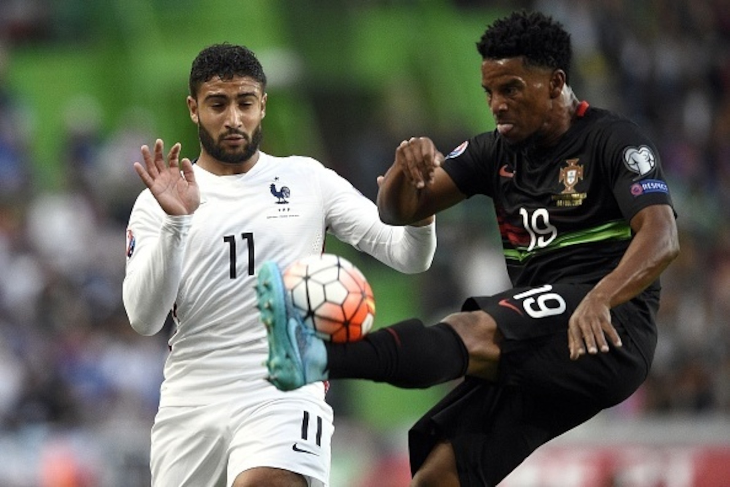 France's forward Nabil Fekir (L) vies with Portugal's defender Eliseu during the Euro 2016 friendly football match Portugal vs France at the Jose Alvalade stadium in Lisbon on September 4, 2015.   AFP PHOTO/ FRANCK FIFE        (Photo credit should read FR