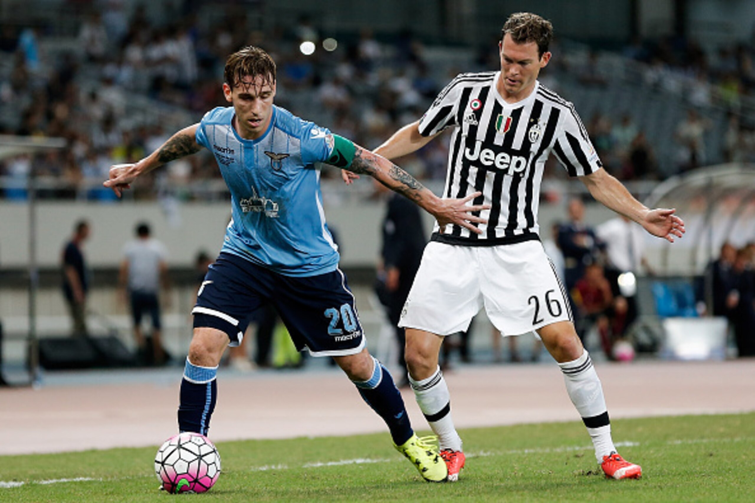 SHANGHAI, CHINA - AUGUST 08:  Stephan Lichtsteiner (L) of Juventus FC contests the ball against Lucas Biglia (R) of Lazio during the Italian Super Cup final football match between Juventus and Lazio at Shanghai Stadium on August 8, 2015 in Shanghai, China
