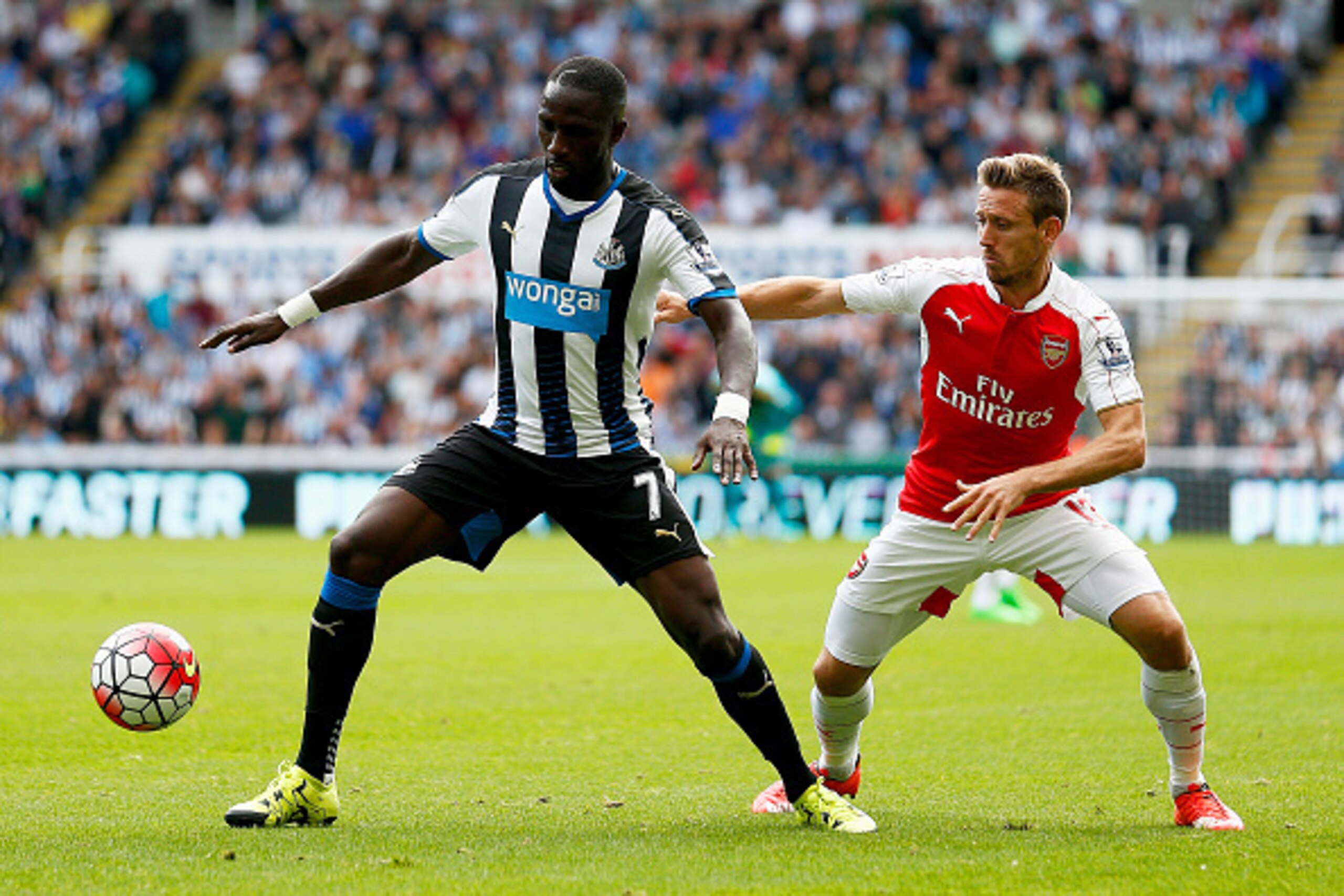 NEWCASTLE UPON TYNE, ENGLAND - AUGUST 29: Moussa Sissoko of Newcastle United and Nacho Monreal of Arsenal compete for the ball during the Barclays Premier League match between Newcastle United and Arsenal at St James' Park on August 29, 2015 in Newcastle 