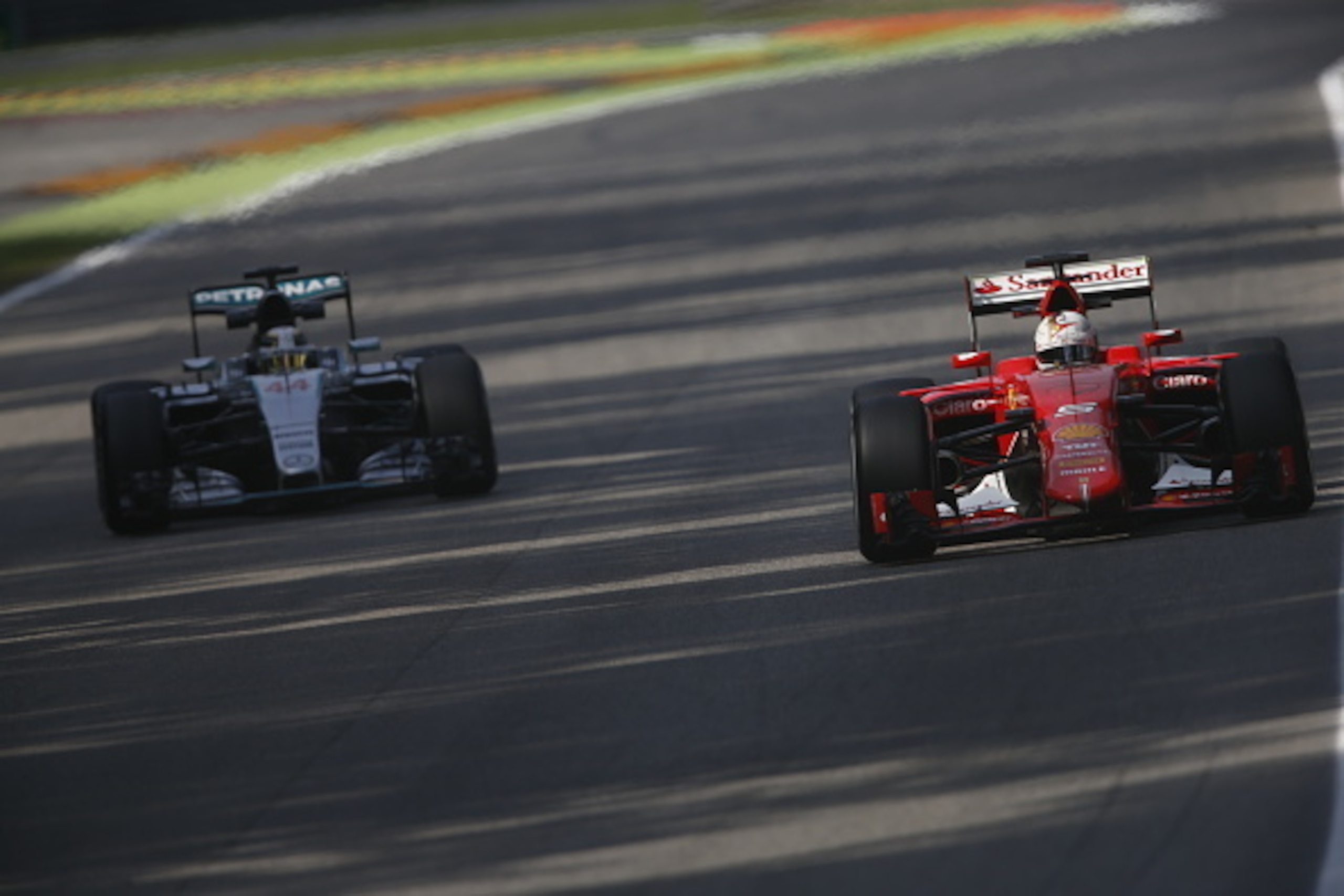 MONZA, ITALY - SEPTEMBER 04:  Sebastian Vettel of Germany and Ferrari drives ahead of Lewis Hamilton of Great Britain and Mercedes GP during practice for the Formula One Grand Prix of Italy at Autodromo di Monza on September 4, 2015 in Monza, Italy.  (Pho
