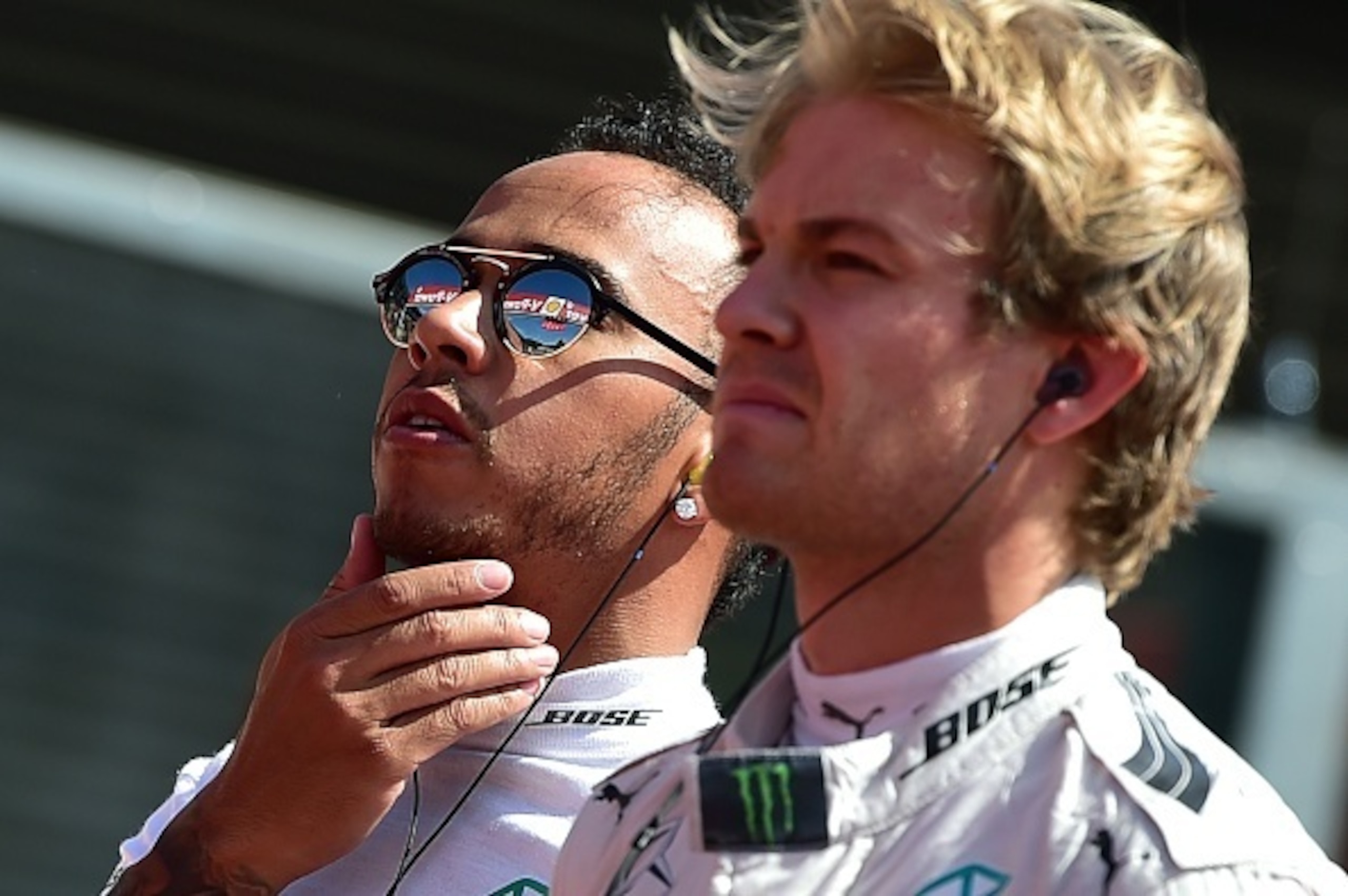 Mercedes AMG Petronas F1 Team's British driver Lewis Hamilton (L) and Mercedes AMG Petronas F1 Team's German driver Nico Rosberg stand on the grid at the Spa-Francorchamps circuit in Spa on August 23, 2015, before the Belgian Formula One Grand Prix. AFP P