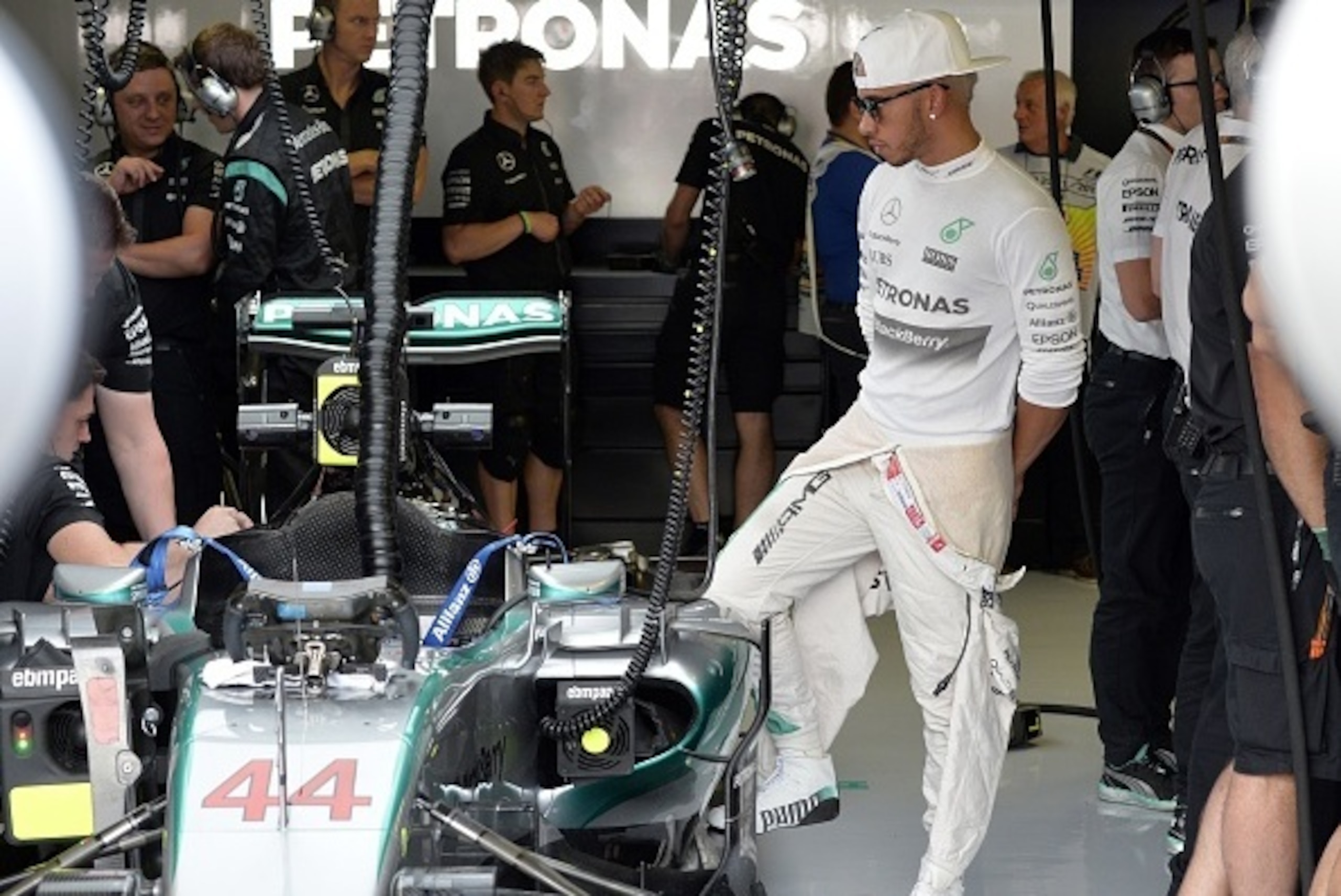 Mercedes AMG Petronas F1 Team's British driver Lewis Hamilton stands next to his car during the practice session at the Autodromo Nazionale circuit in Monza on September 4, 2015 ahead of the Italian Formula One Grand Prix.  AFP PHOTO / ANDREAS SOLARO     