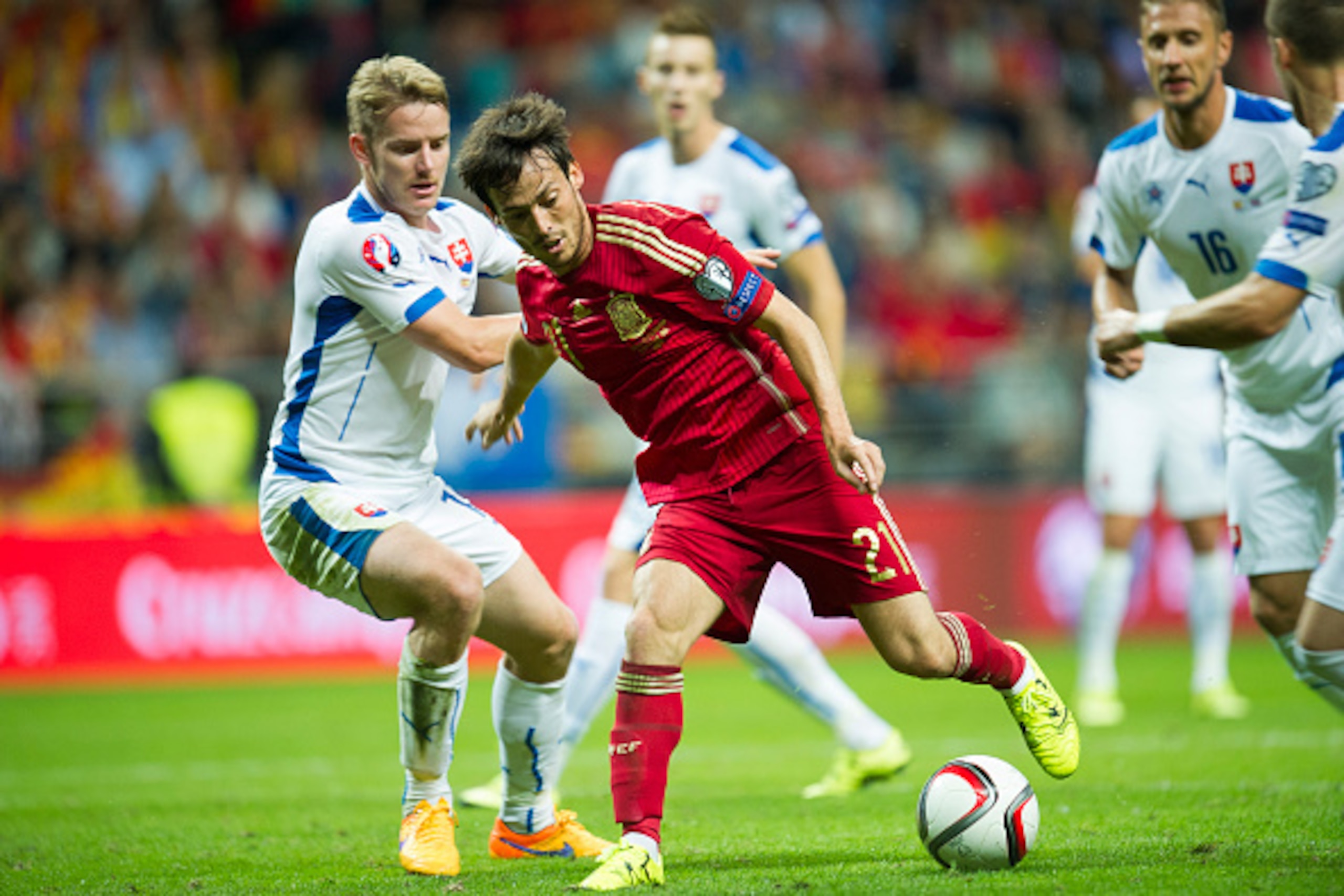 OVIEDO, SPAIN - SEPTEMBER 05: David Silva of  Spain duels for the ball with Tomas Hubocan of Slovakia during the Spain v Slovakia EURO 2016 Qualifier at Carlos Tartiere on September 5, 2015 in Oviedo, Spain.  (Photo by Juan Manuel Serrano Arce/Getty Image