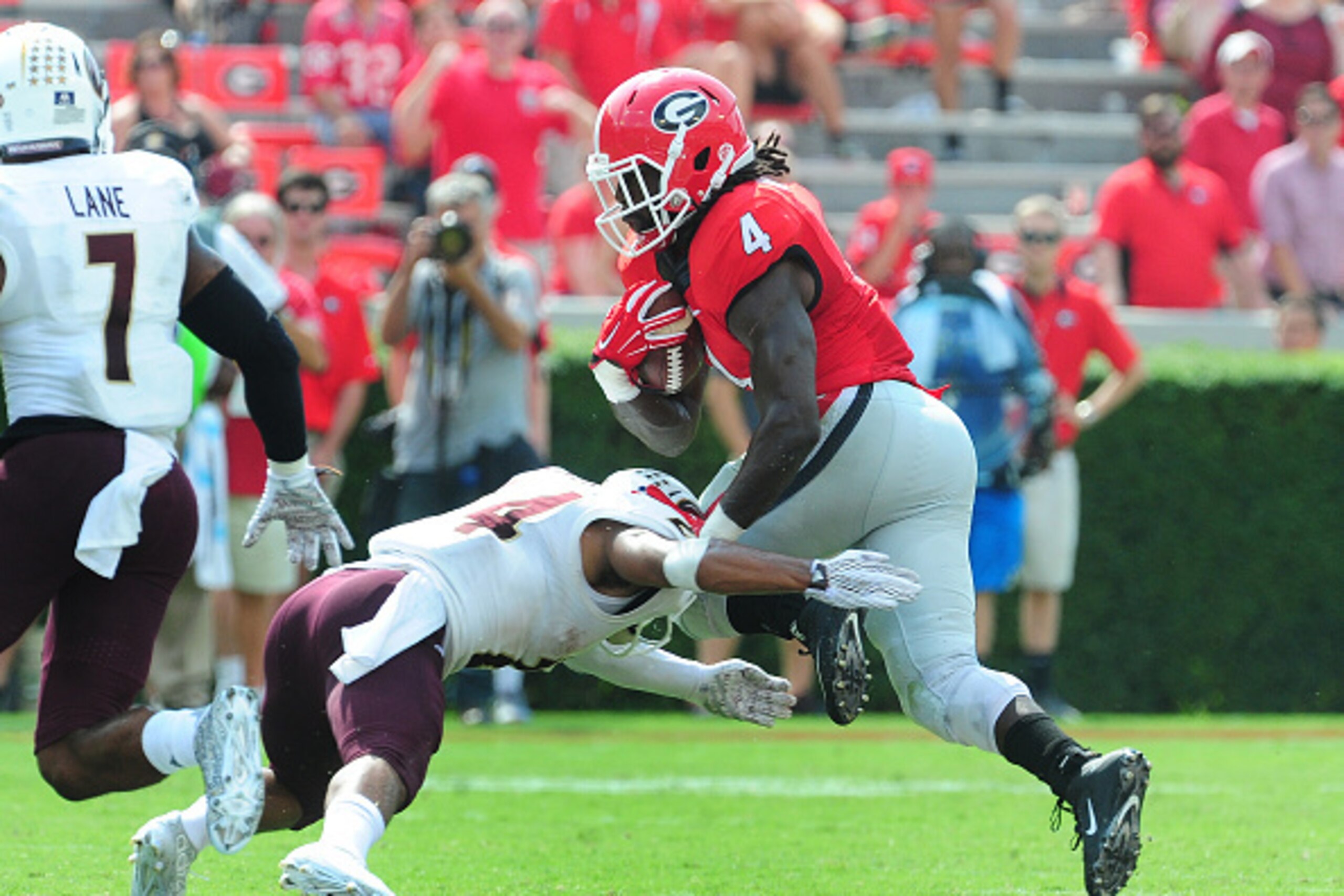 ATHENS, GA - SEPTEMBER 5: Tre' Hunter #4 of the Louisiana Monroe Warhawks attempts to tackle Keith Marshall #4 of the Georgia Bulldogs on September 5, 2015 in Atlanta, Georgia. (Photo by Scott Cunningham/Getty Images)