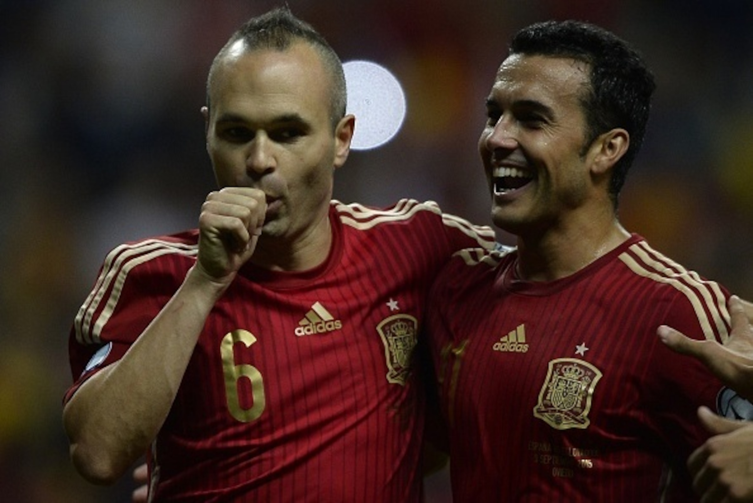 Spain's midfielder Andres Iniesta (L) celebrates with Spain's forward Pedro Rodriguez after scoring a goal during the Euro 2016 qualifying football match Spain vs Slovakia at the Carlos Tartiere stadium in Oviedo on September 5, 2015.  AFP PHOTO/ MIGUEL R