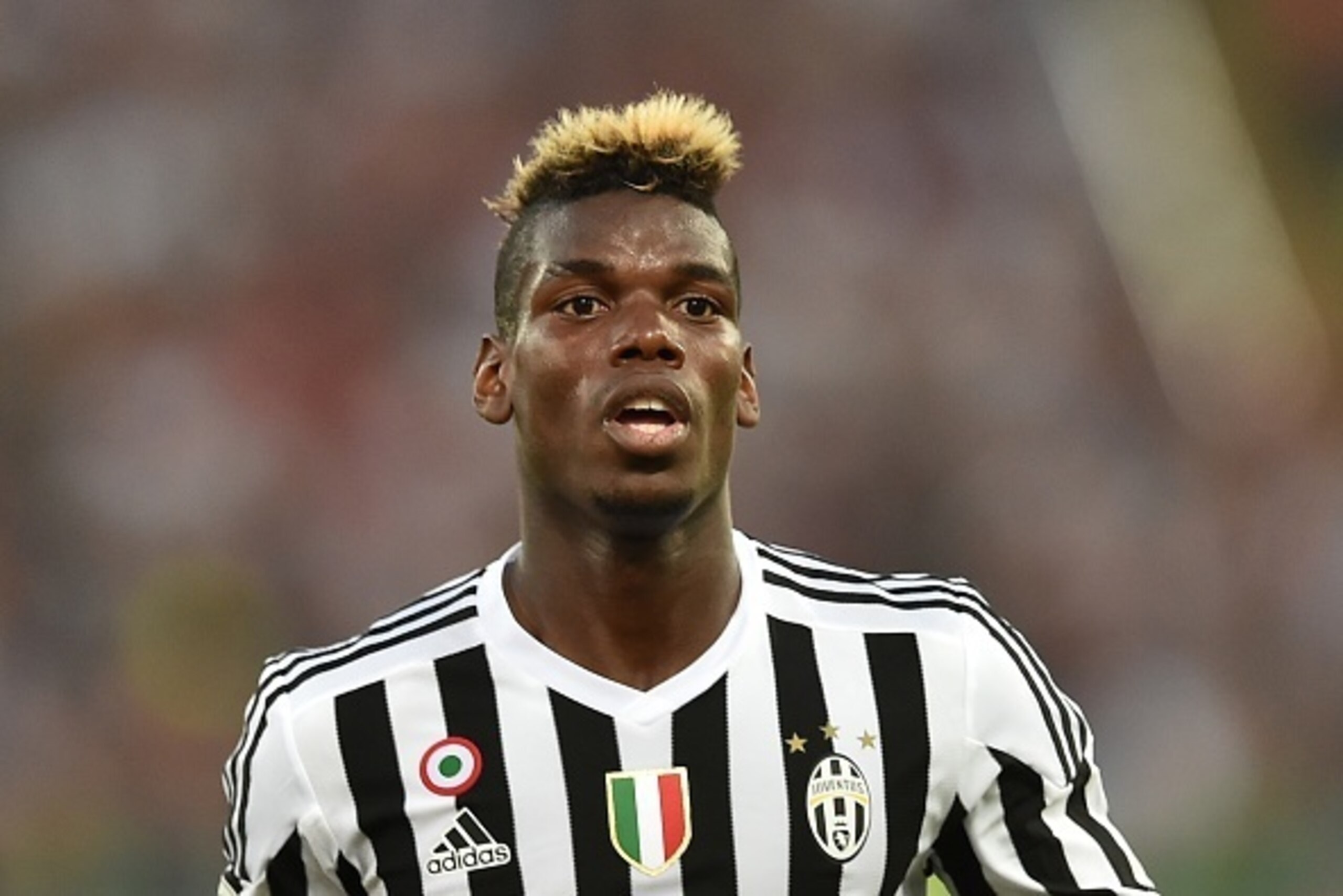 Juventus' midfielder from France Paul Pogba reacts during the Italian Serie A football match AS Roma vs Juventus on August 30, 2015 at the Olympic stadium in Rome.  AFP PHOTO / ALBERTO PIZZOLI        (Photo credit should read ALBERTO PIZZOLI/AFP/Getty Ima