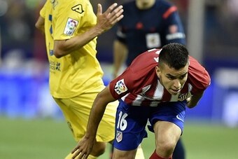 Atletico Madrid's Brazilian defender Filipe Luis (R) vies with Atletico Madrid's Argentinian midfielder Angel Correa during the Spanish league football match Club Atletico de Madrid vs UD Las Palmas at the Vicente Calderon stadium in Madrid on August 22, 