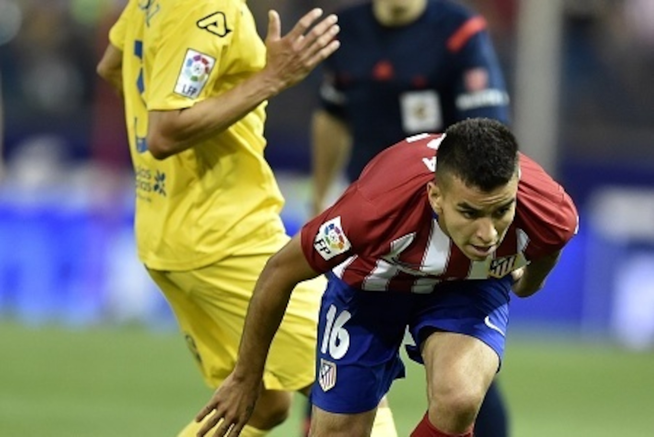 Atletico Madrid's Brazilian defender Filipe Luis (R) vies with Atletico Madrid's Argentinian midfielder Angel Correa during the Spanish league football match Club Atletico de Madrid vs UD Las Palmas at the Vicente Calderon stadium in Madrid on August 22, 
